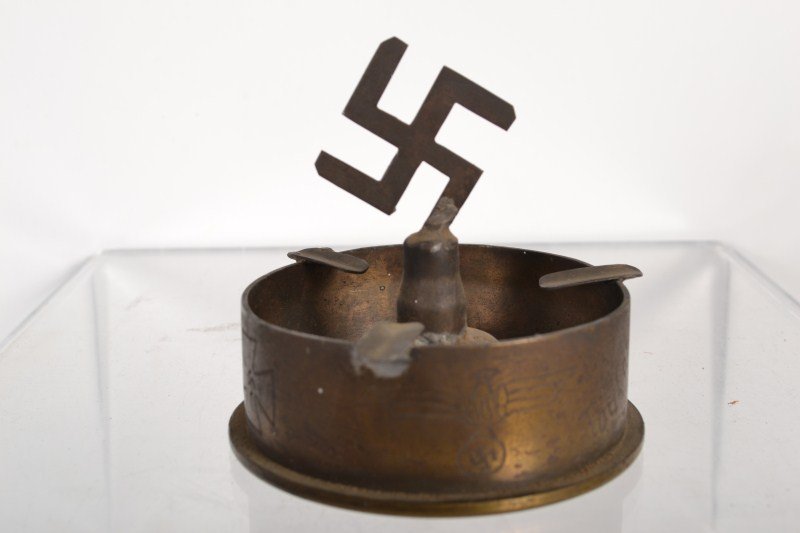 WWII German (Nazi) Trench Art: WWII German (Nazi) Trench Art ashtray made from 6mm C/12 NASE case and other base metal, with a swastika finial inscribed "Toulon" 1944