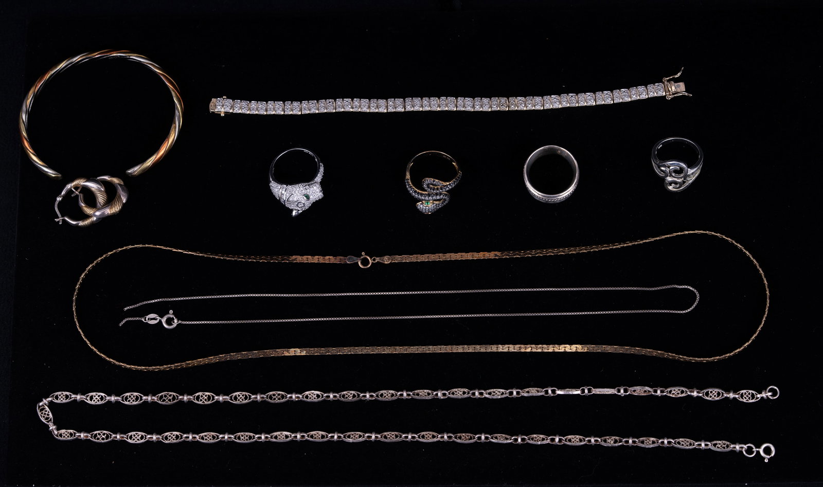 Sterling Silver Jewelry Grouping: Silver jewelry consists of a heavy two tone sterling marked cuff bracelet, sterling marked two tone hoop earrings, goldtone sterling bracelet, goldtone sterling Italian 23" chain with sophisticated li