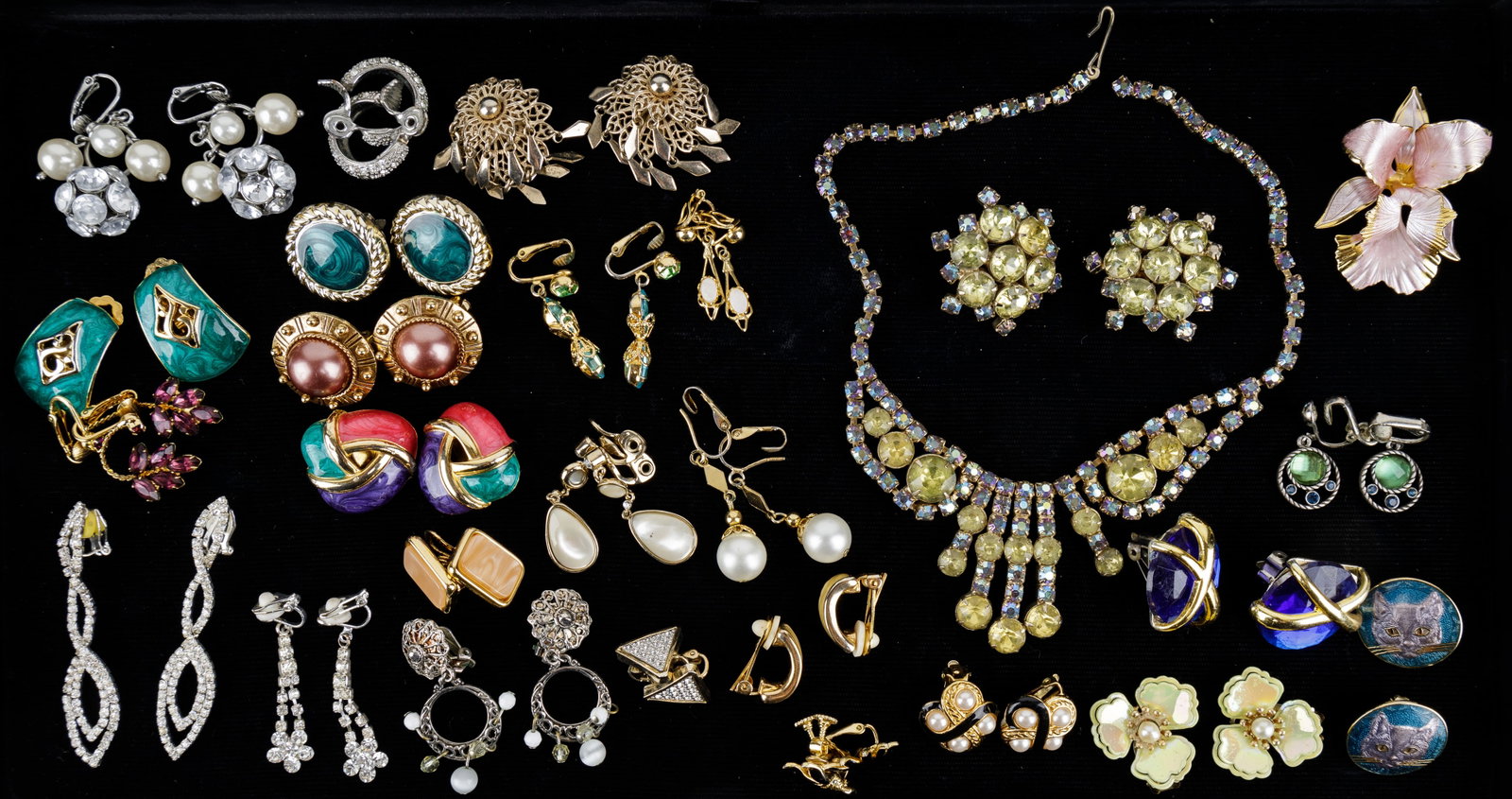 Vintage Costume Jewelry, Rhinestone: Lot of costume jewelry includes an orchid brooch signed Cerrito, earrings including enamel cats, gold tone and silver tone and more clip earrings. There is a matching rhinestone necklace and clip earr
