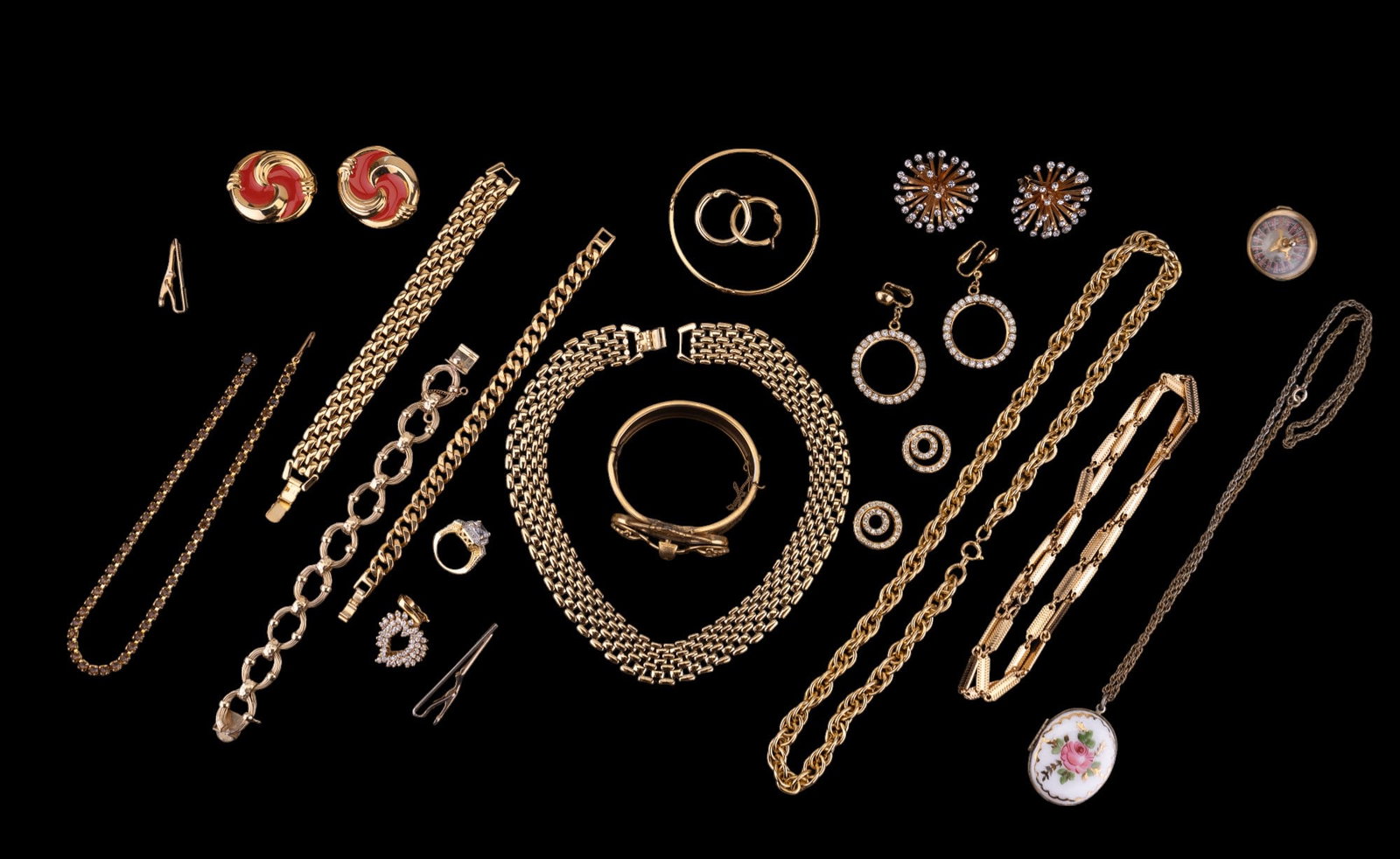Goldtone, Rhinestone, Monet & more Jewelry: A grouping of quality goldtone jewelry including bracelets, cuff bracelets, a Monet bangle bracelet, rhinestone earrings & pendants, goldtone chains, money clips & more.