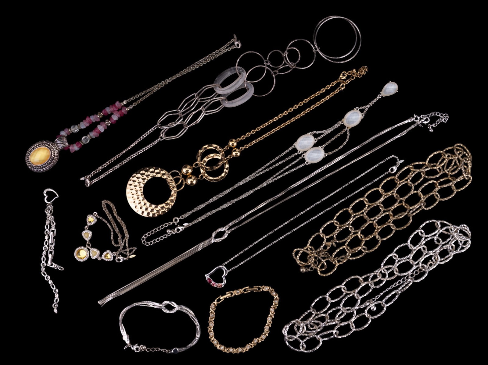 Vintage & more Avon Jewelry Grouping: Grouping of Avon jewelry, consisting of two rhinestone bracelets, a silvertone clear faceted stone necklace, pin and white beaded necklace w/ large pendant, large goldtone chain, large silvertone chai