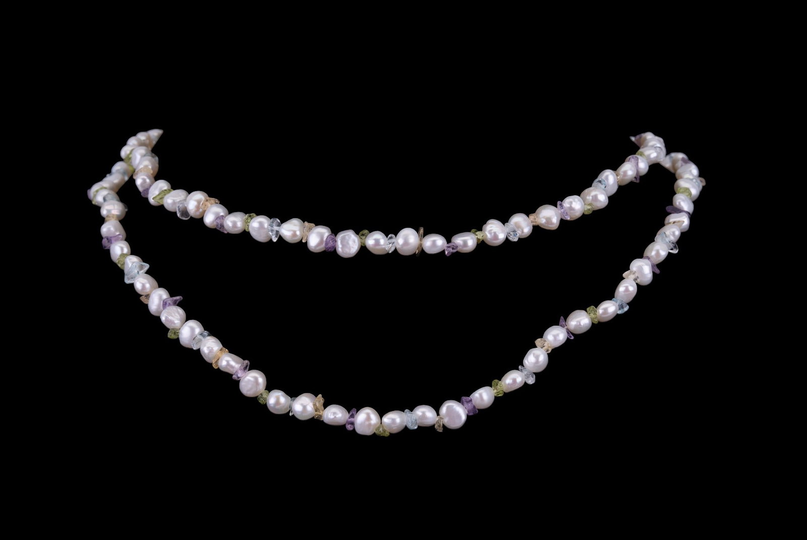 14K, Honora Freshwater Pearl Necklaces: Grouping of two freshwater pearl necklaces: A 14K gold freshwater pearl necklace with garnet beads, along with a Honora long freshwater pearl necklace (bag included). 14K necklace measures approx. 18.