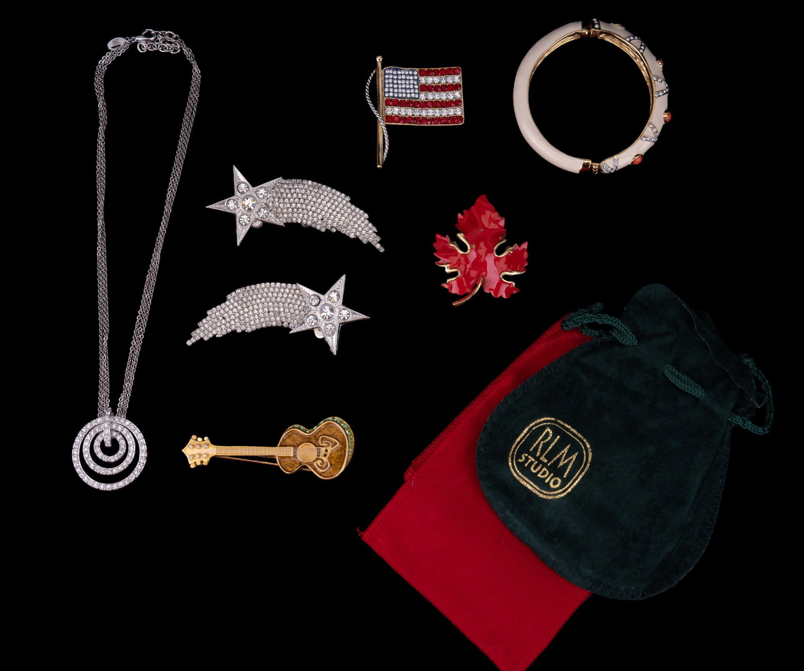 Nolan Miller, KJL Kirk's Folly & more.: A silvertone rhinestone Nolan Miller necklace with original box, KJL enamel cuff bracelet with KJL carrying bag, KJL rhinestone flag pin with carrying bag, two Kirk's Folly rhinestone star brooches, B