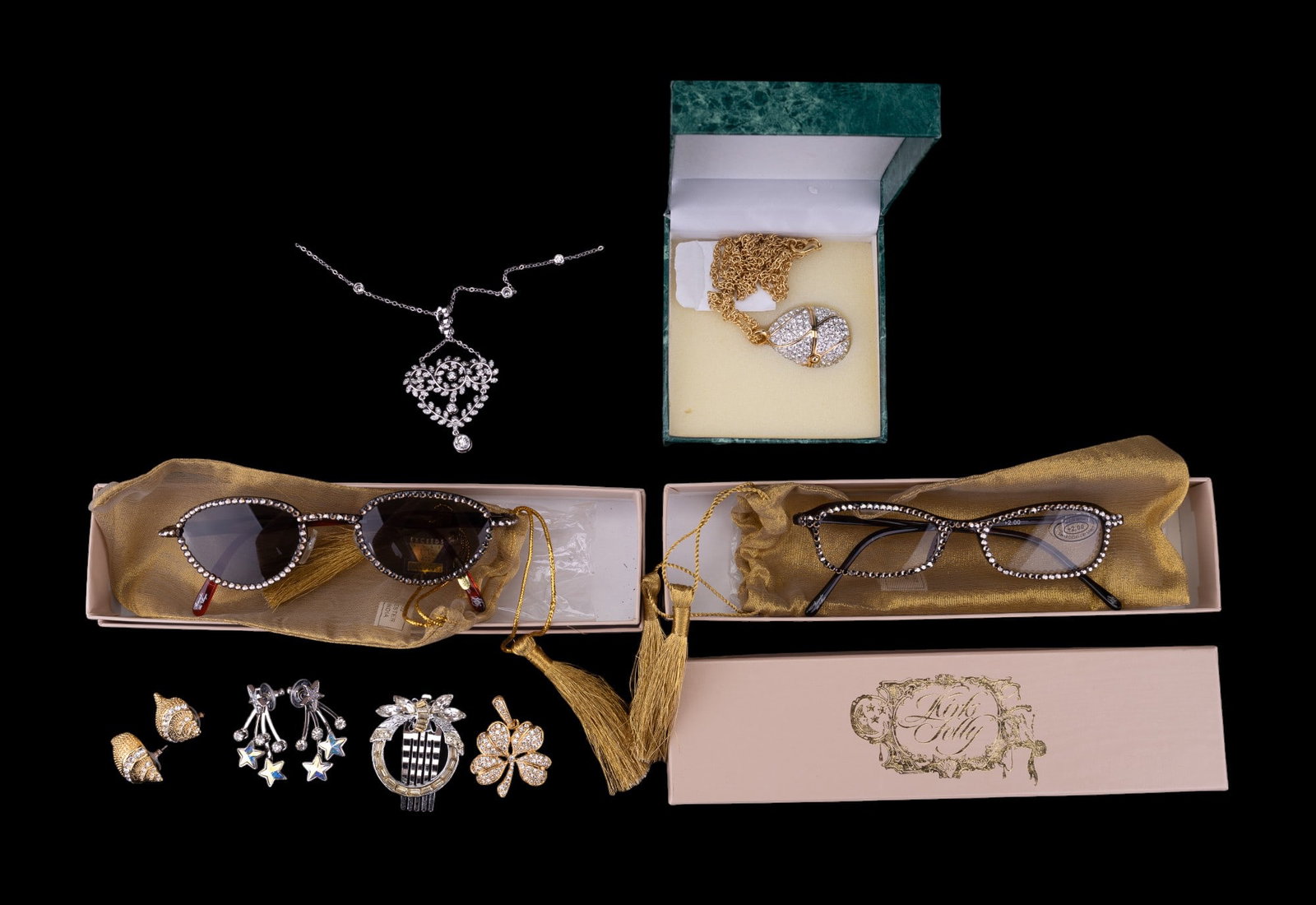Suzanne somers, Kirk's Folly, KJL, more Costume: Grouping includes two pairs of Kirk's Folly swarovski crystal glasses with original packaging, rhinestone lapel pin, Kirk's folly star earrings, KJL conch earrings, clover rhinestone KJL earrings, a S