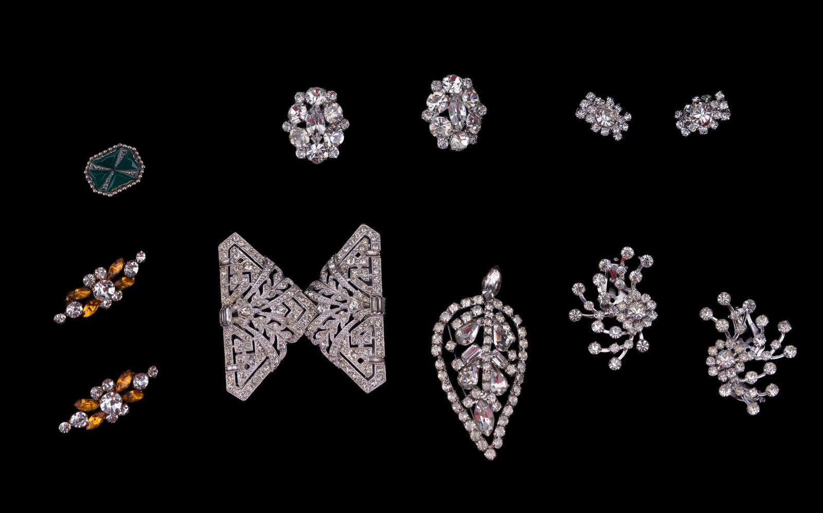 Crystal/Rhinestone Brooches, Earrings, Vintage: three pairs of crystal/rhinestone clip earrings, a crystal/rhinestone belt buckle, crystal/rhinestone leaf brooch, and two vintage occupied German orange crystal/rhinestone brooches.