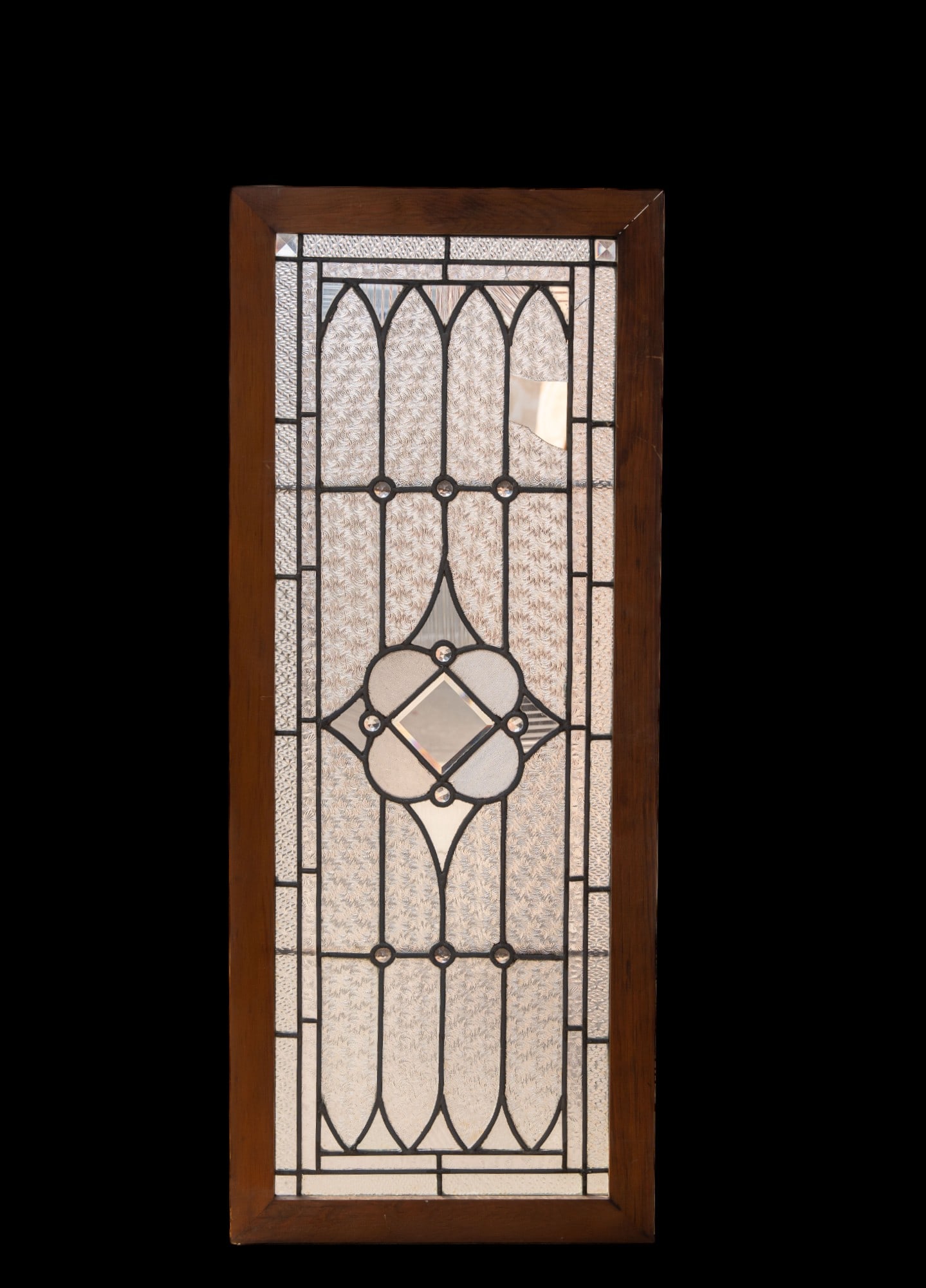 Vintage Art Nouveau Style Leaded Glass Window: Art Nouveau style leaded glass window with various texture patterned clear glass in display frame measuring approx. 16.25" W x 40.5" H. One piece of glass has loss.