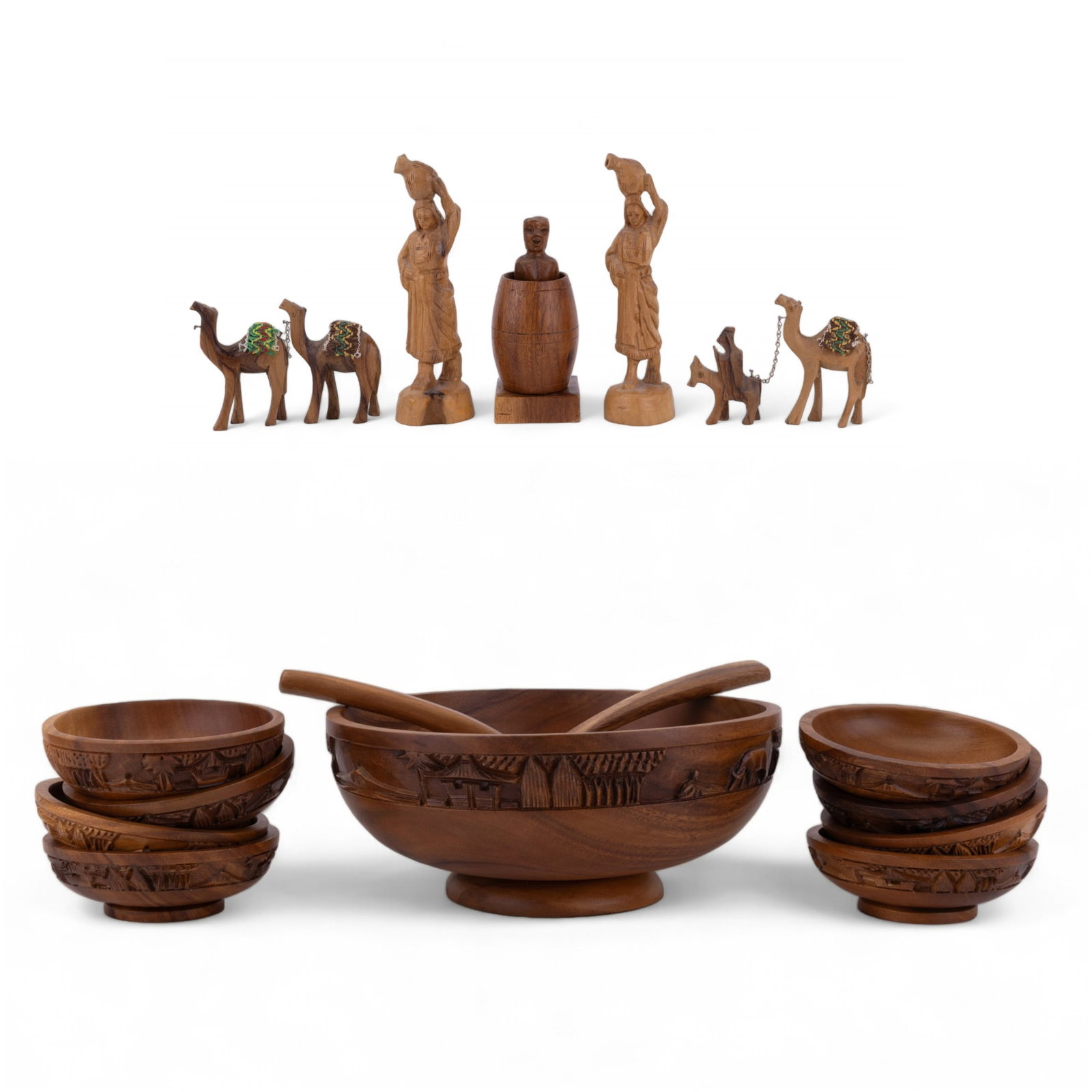 Saudi Hand Carved Wood Figures (5), Salad Set: Five hand carved Saudi wood figurines, including two pairs of camels, two women holding water vessels, and a lewd man with barrel. Tallest figurine measures approx. 7.75" high. Also included is a carv