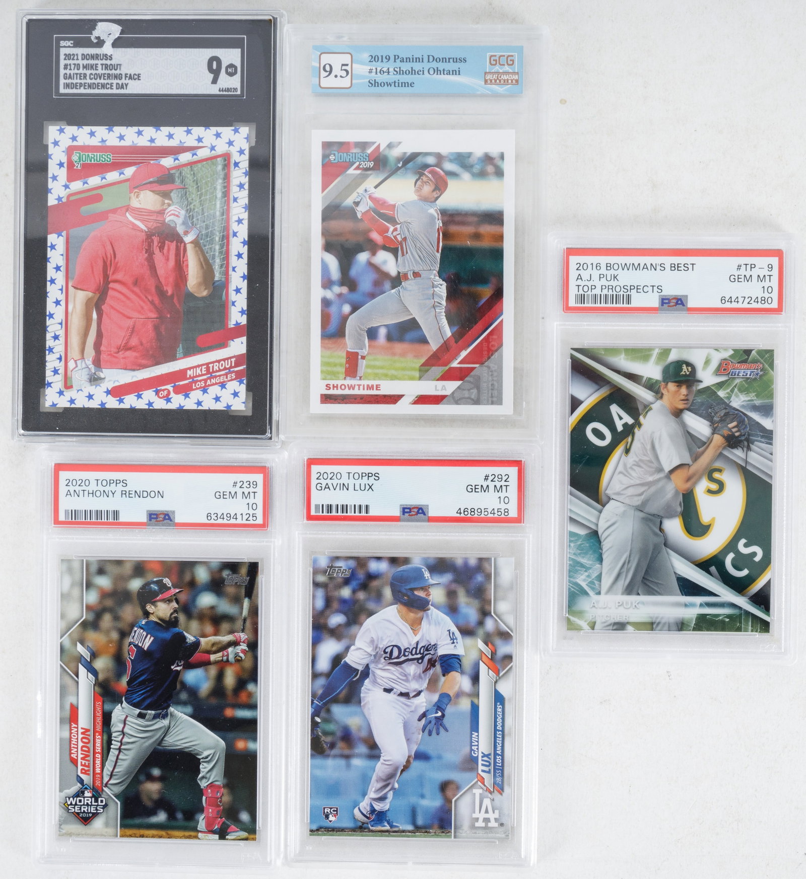 Graded Baseball Cards (5) 2016-2021: Graded cards include 2021 Donruss Mike Trout Gaither Covering Face, 2019 Panini Donruss Shohei Ohtani Showtime, 2016 Bowman's Best A.J. Puk Top Prospects, and 2020 Topps Anthony Rendon & Gavin Lux. Ca