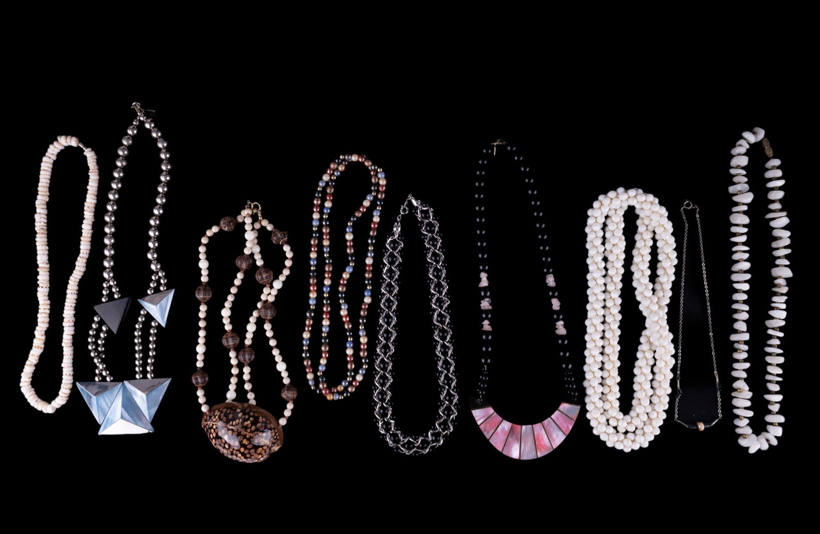 Signed and Seashell Statement Necklaces: 2 Karla Jordan necklaces with pink MOP and rose quartz accents; blue MOP style and silver tone, Trifari silver tone woven black bead necklace, large shell and other style necklaces.