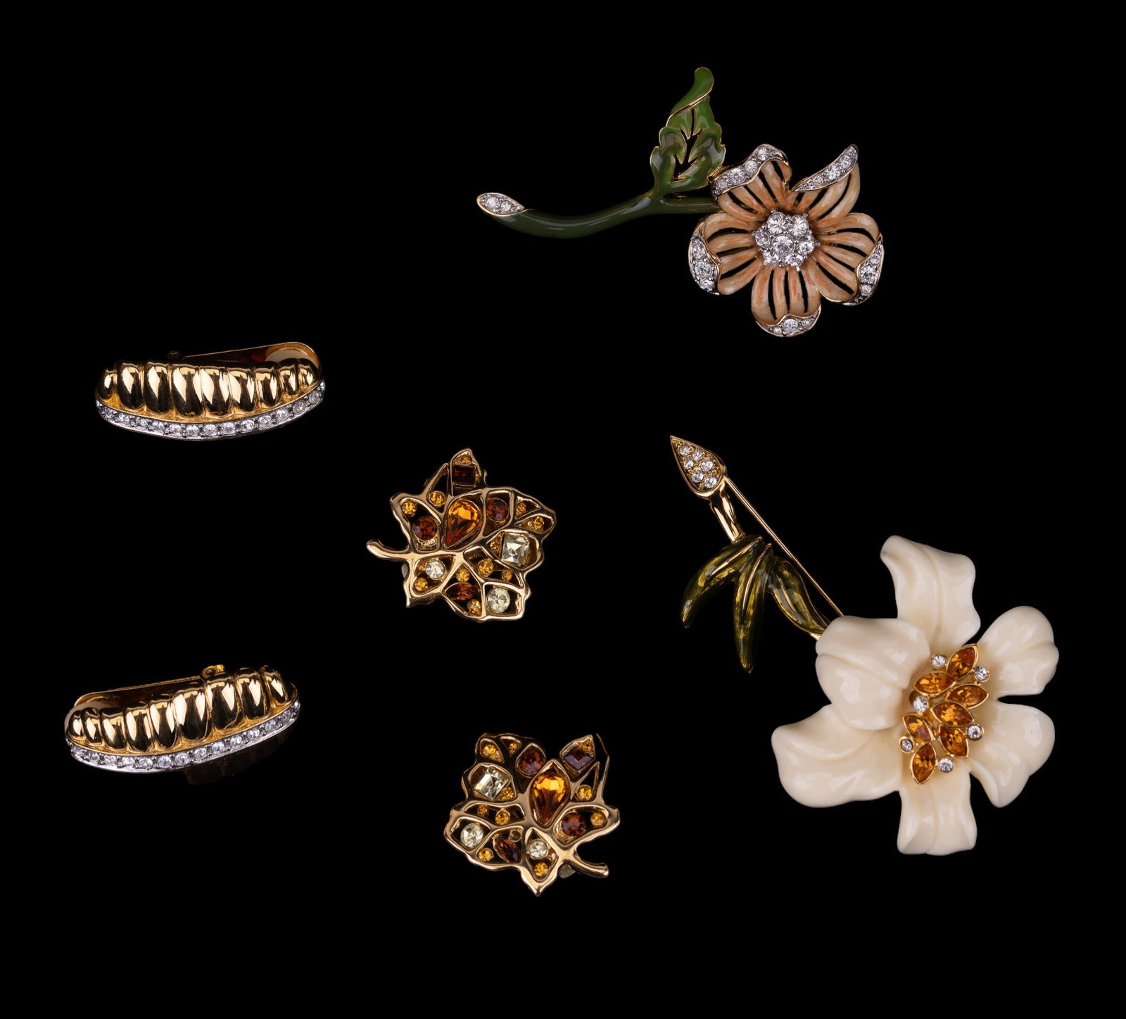 Nolan Miller Designer Jewelry: Nolan Miller jewelry including 2 large floral crystal brooches and 2 pair of large gold tone multi-hue and clear crystal clip earrings.