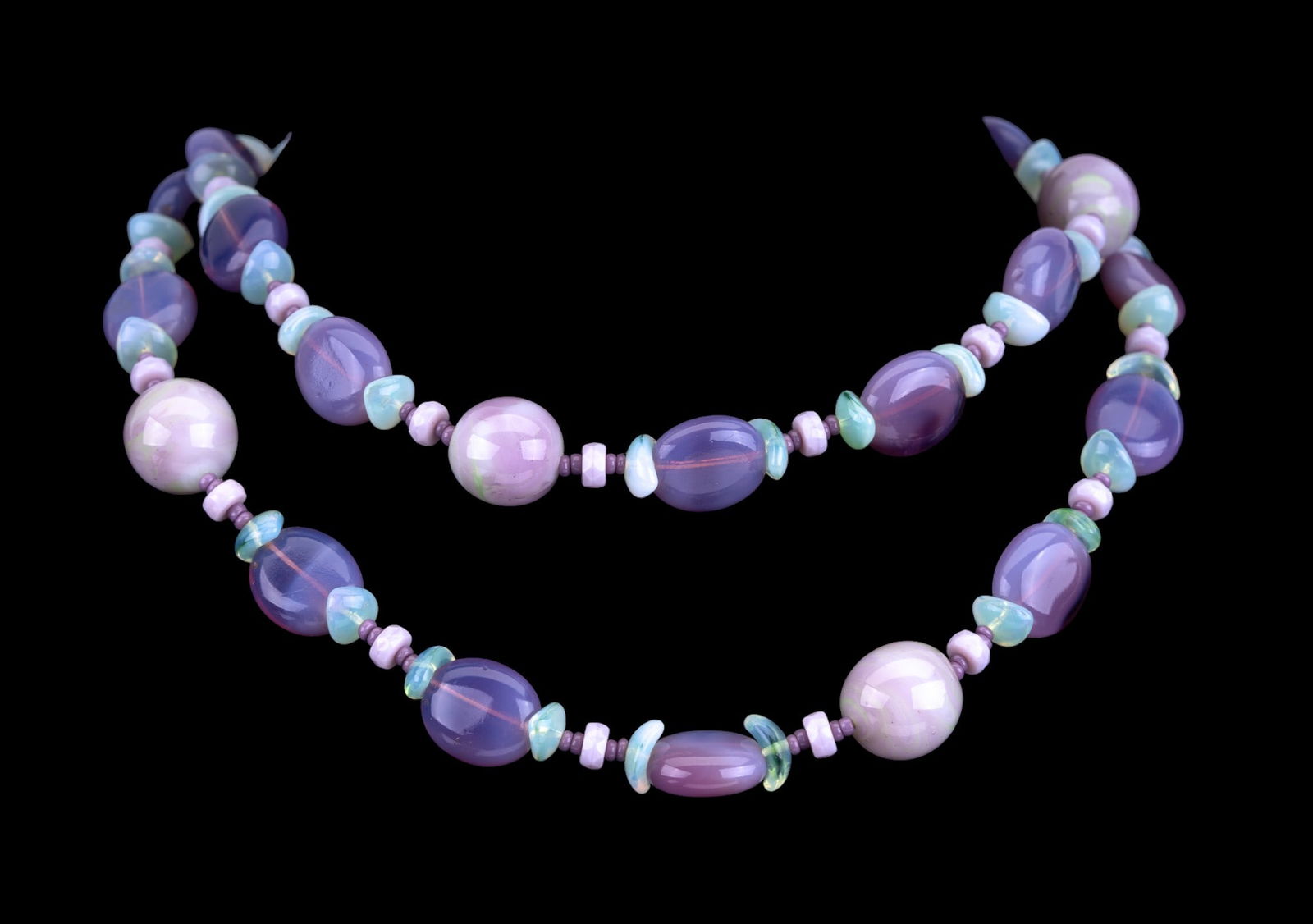 Miriam Haskell Multi-Stone Necklace: A Miriam Haskell necklace with multiple different stone with different shades. Includes spherical, oblong, & ovular stone shapes. Necklace measures approx. 35" long end to end.