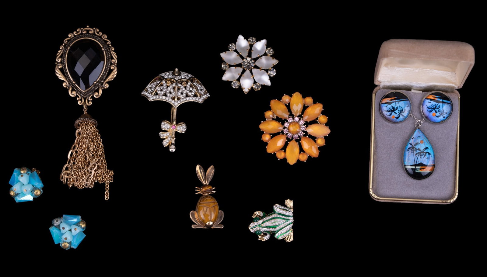 G.F, Carolee, Austrian Crystal Jewelry: Grouping includes a Chico's tasseled gold ton brooch, West German vintage blue earrings, 12K gold filled tiger eye bunny brooch, Austrian crystal flower brooch, rhinestone flower brooch marked "LC" on