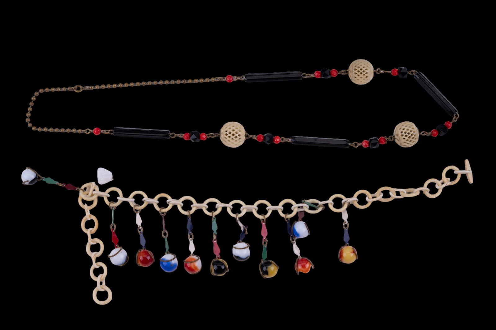 Vintage/Semi-Antique Celluloid Necklaces (2): Two vintage or semi antique celluloid necklaces. One necklace has a metal chain with celluloid beads, including large carved white beads. Other is a celluloid chain measuring approx. 15.5" long with m