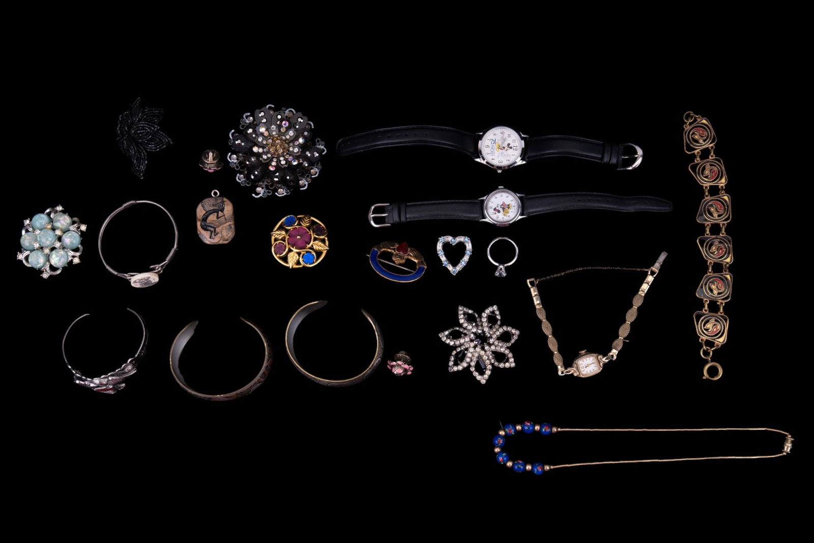 Vintage & more Costume Jewelry: Grouping of vintage costume jewelry & more, including two Reed & Baton art cuff bracelets, a vintage black & clear rhinestone brooch, two Disney brand watches, a vintage black rhinestone brooch, vinta