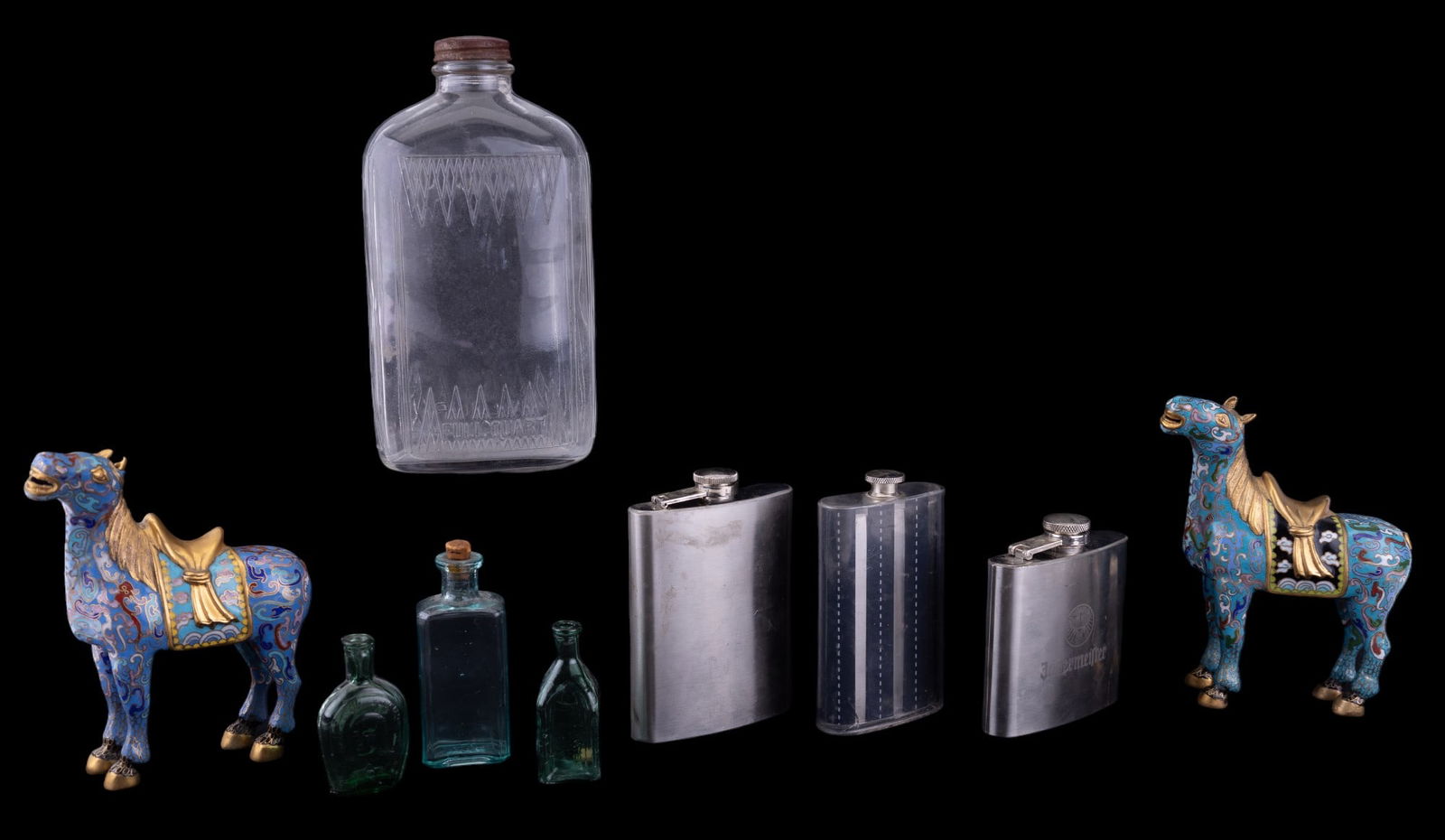 Vintage Bottles, Flasks, & Cloisonne Horses: 7 bottles, the largest being a full quart. Small green glass bottles are from Taiwan, one features a depiction of Benjamin Franklin. Also included are 3 stainless steel pocket flasks & 2 cloisonne hor