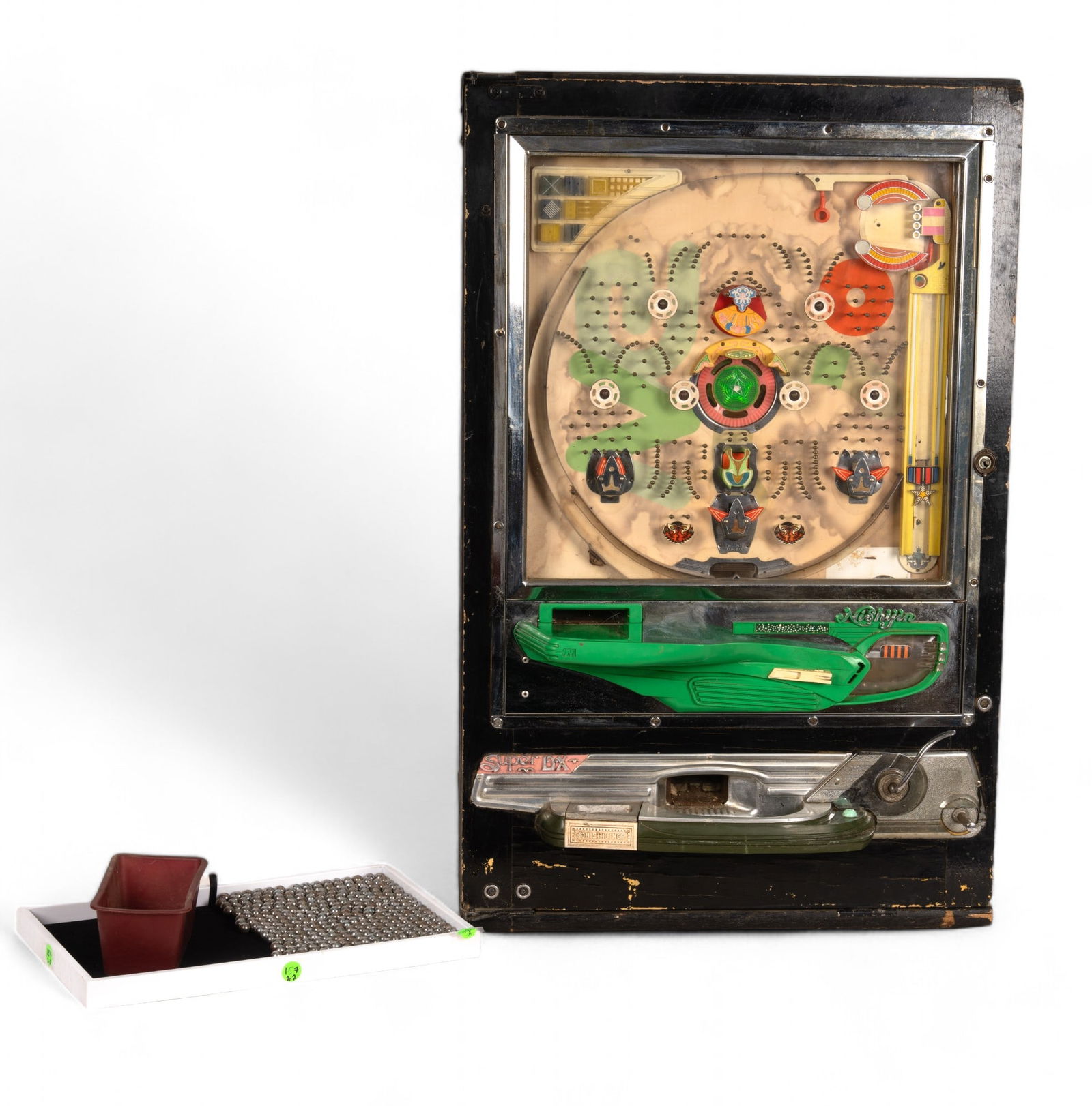 Nishijin Super DX Vintage Pachinko Machine: A Nishijin super DX vintage pachinko machine measuring approx. 32" high x 20.5" across.Mechanical components are working and do not have loss, but item has not been plugged in to check functionality o