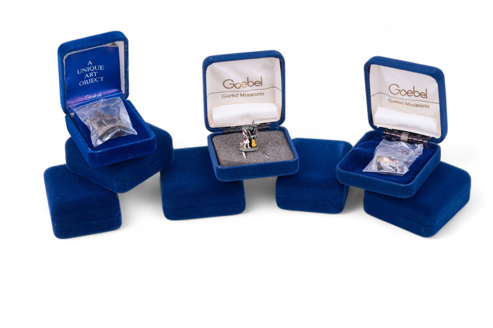 Goebel Miniatures by "Olzewski" (8): 8 total Goebel manures made by "Olzewski", including 3 of The Cowardly Lion, 2 of Dorothy & The Wicked witch, Eyes on the Horizon (American Series), The Geisha (Oriental Series), & Masquerade - St. Pe