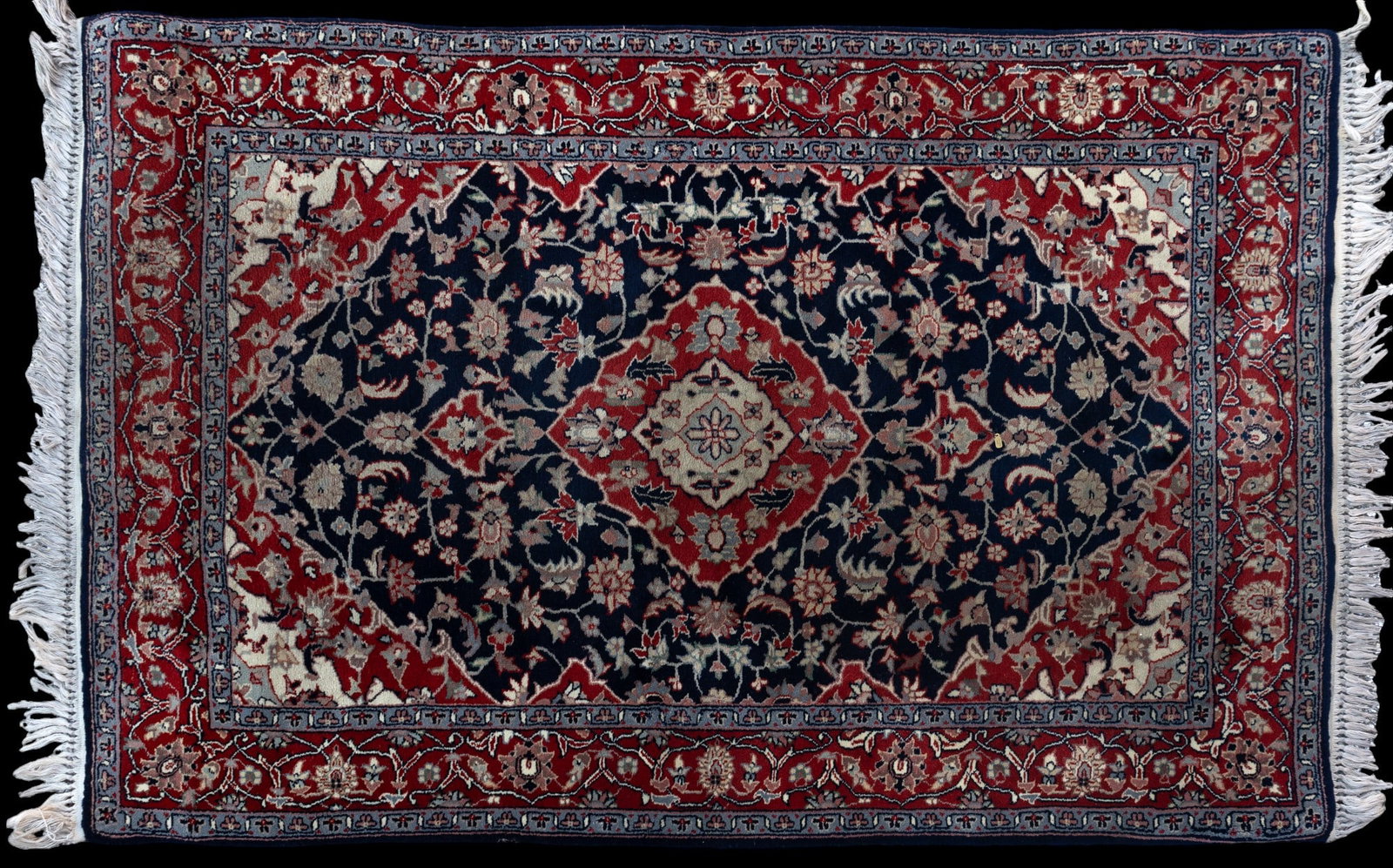 Oriental Hand Knotted High Quality Rug: An approx 4' by 6' oriental hand knotted rug in very good shape. Pile is in great condition, minimal fading or discoloration as seen in photography.