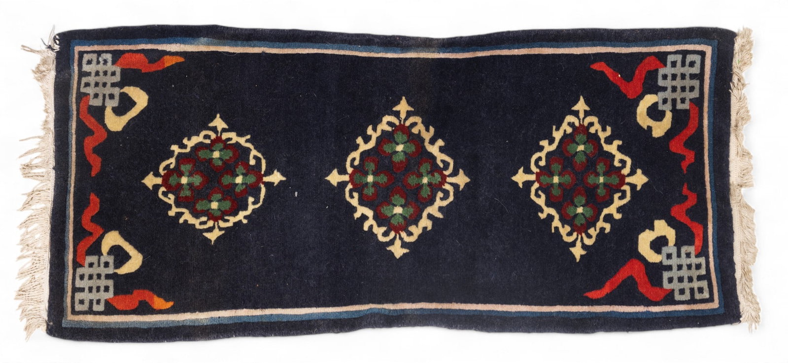 Tibetan Hand-Woven Art Deco Rug: A Tibetan hand-woven rug measuring approx. 48" x 22". Rug has loss on lower left corner, otherwise good condition as seen in photography.