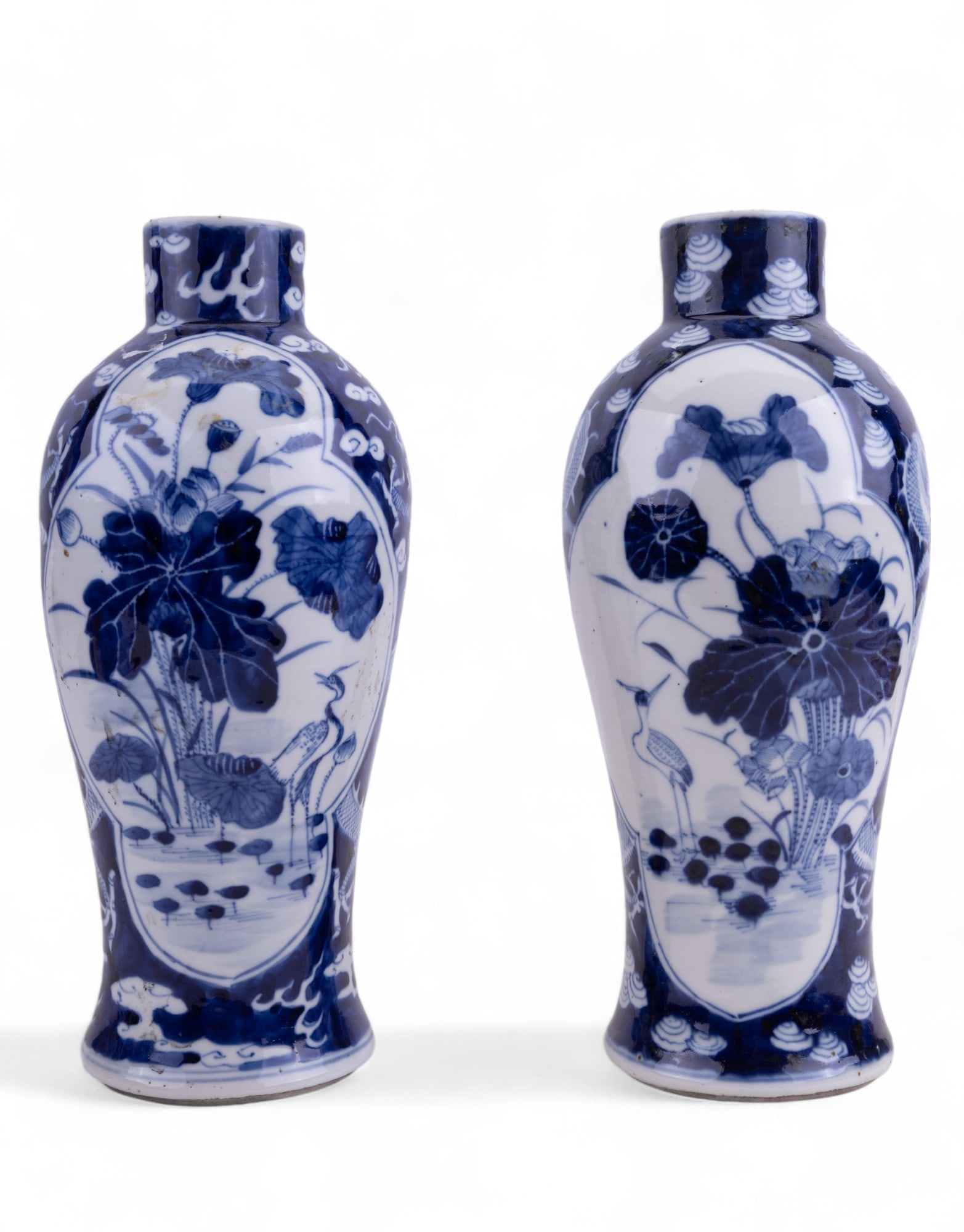 Chinese Blue & White Porcelain Vase Pair: Pair of Chinese blue & white porcelain vases w/ holes on the bottom, indicating that at one point they were converted into lamps. Both have 4-character marks on the bottom where the holes were drilled