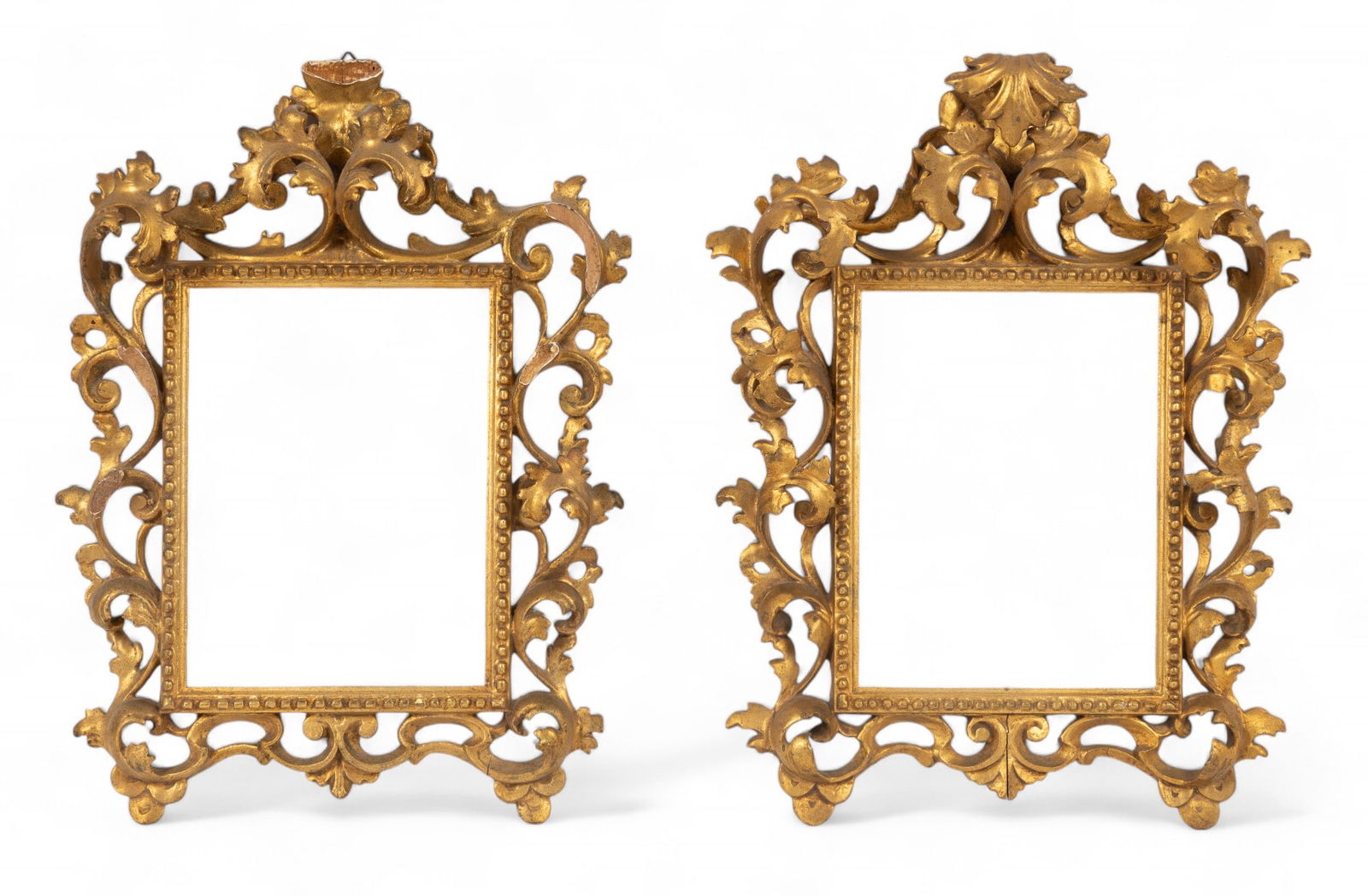 Hand Carved Gilt Rococo Picture Frames (2): 2 hand carved gilt Rococo picture frames with floral motifs measuring approx. 14" W x 18" H OD with windows measuring approx. 7" W x 9.25" H windows. Both frames have wear consistent with age; 1 frame