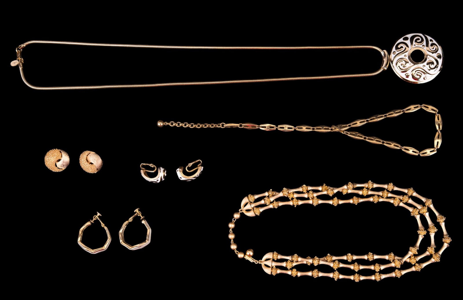 Trifari & Diane Von Furstenberg Jewelry: Trifari gold tone necklace with matching clip earrings, Trifari link chain, & a Diane Von Furstenberg white enamel necklace with earrings