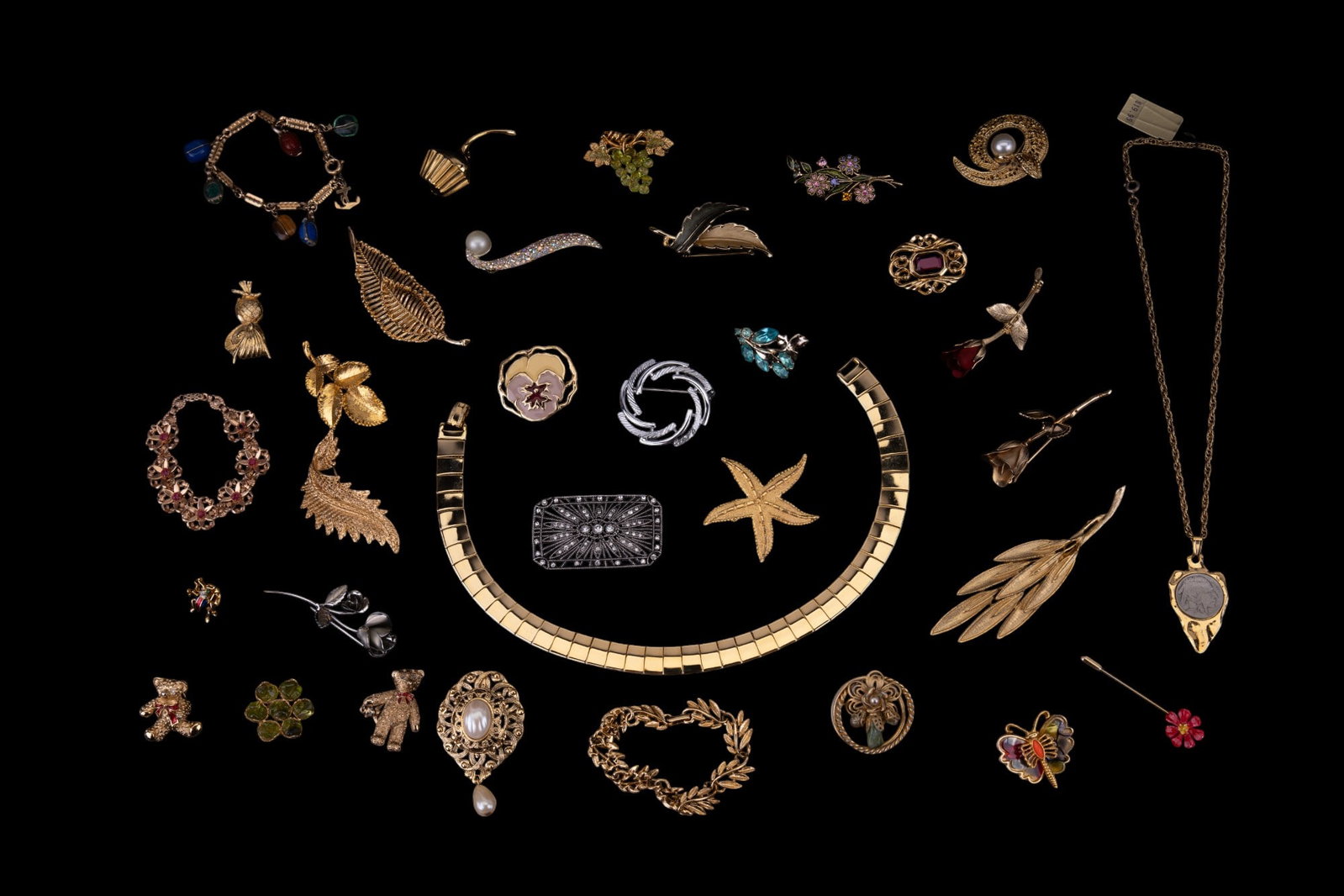 Brooches & Vintage Jewelry: Vintage gold and silver tone brooches feature owl, leaf, floral, whimsical, and other themes, plus a gold tone necklace with central Indian head nickel, Scarab style and gold tone bracelets, and more