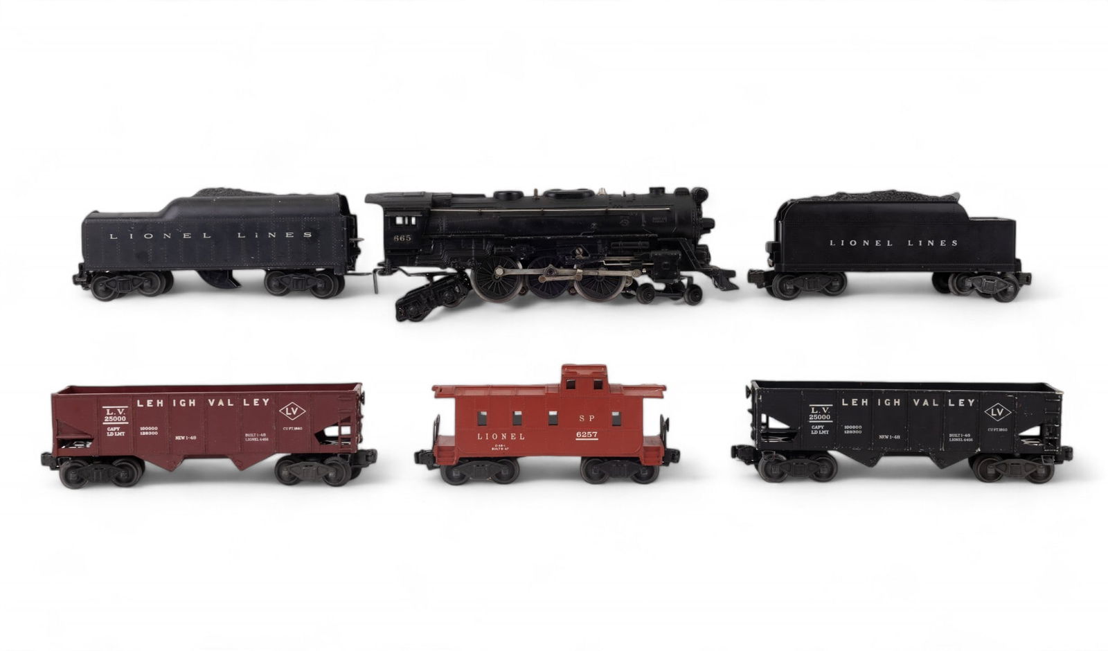 Lionel 665 Locomotive with Tender and Others: Lionel 665 steam locomotive with tender car, caboose, 2 Lehigh Valley coal hoppers, and extra tender car with repair (see photos).