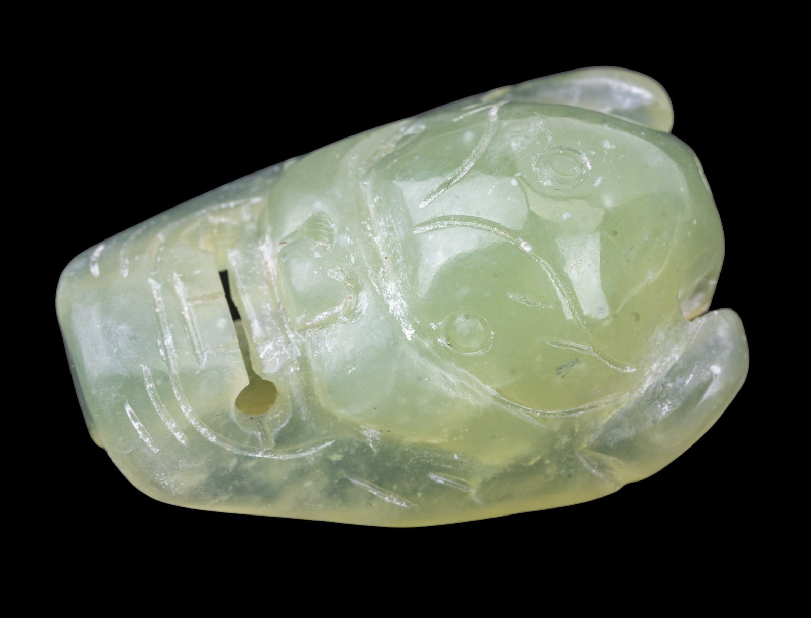 Chinese Carved Jade Foo Dog/Demon Belt Hook: A Chinese carved jade belt hook measuring approx. 2.75" top to bottom and 2" at widest point. Belt hook depicts a foo dog or demon mask.