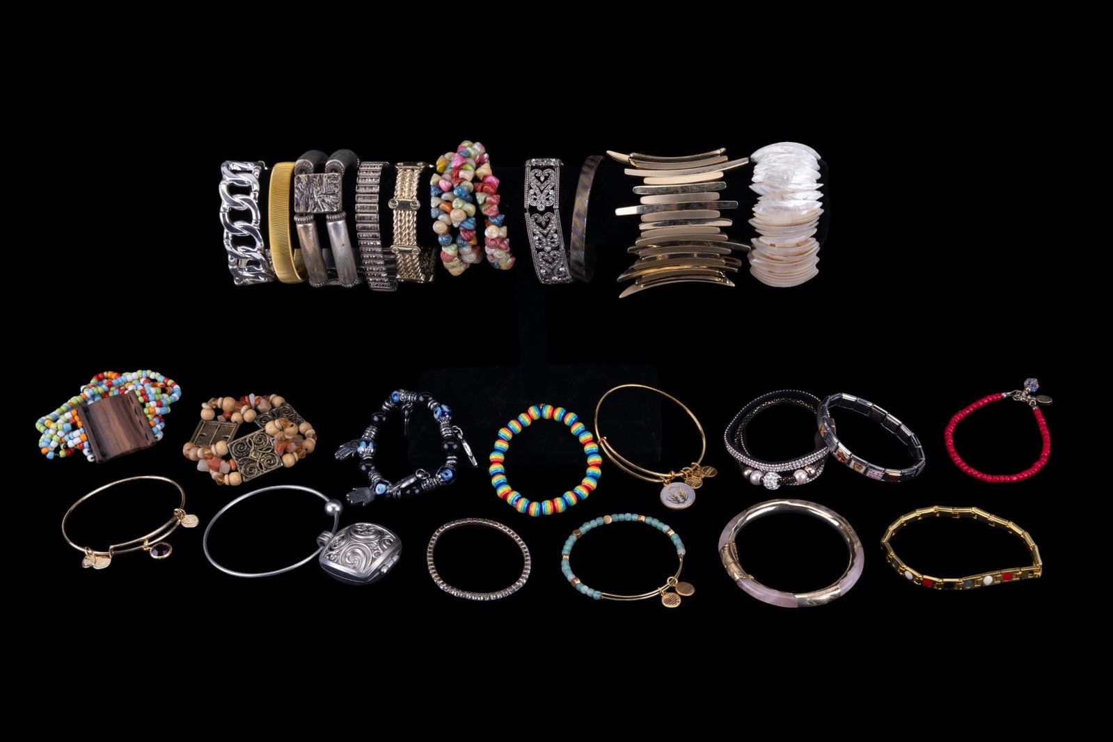 Costume / Ornamental Bracelets (24): Grouping of 24 various ornamental bracelets. Some have colorful beads, some are metal w/ stone accents, many are elastic, some are etched w/ designs, & some are branded (Alex and Ani) (see photos).