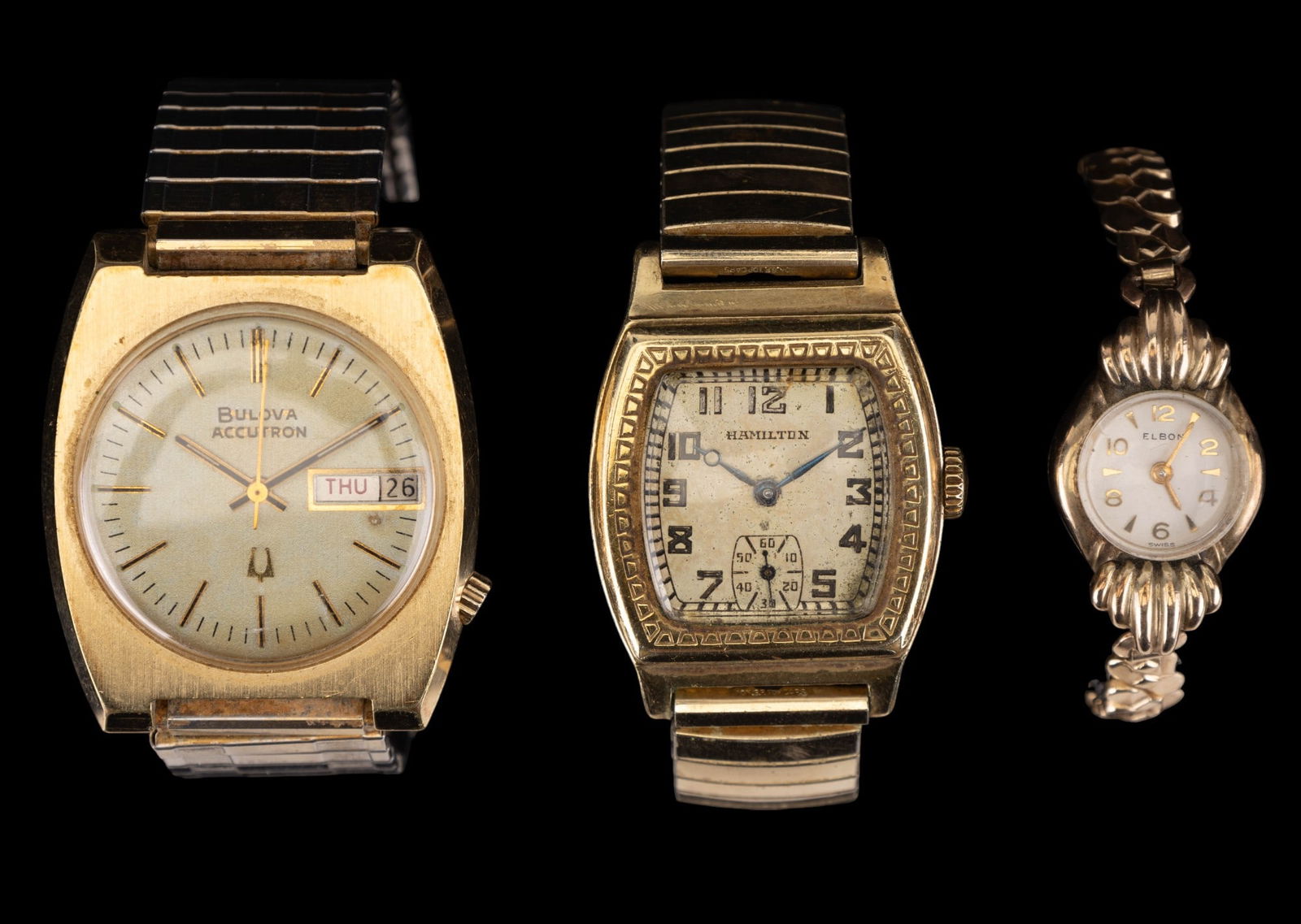 Hamilton, Bulova, & Elbon Wrist Watches: Hamilton wrist watch w/ 10K GF top caps & Speidel stainless steel band, Bulova Accutron 10K rolled golf plate back & gold electroplated bezel J203101 wrist watch w/ Speidel stainless steel band, & Elb