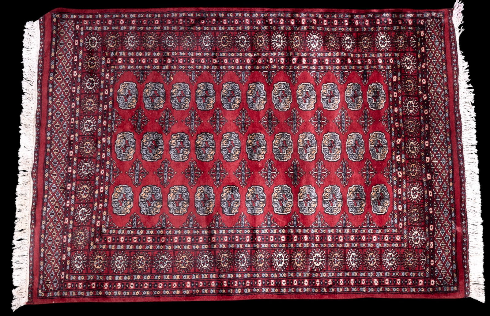 Persian Bokhara Rug: Finely-woven Persian Bokhara rug approx. 4'1" x 6' w/ red, black, tan, bluish gray, & cream / ivory patterns w/ geometric & floral motifs. Item presents well. *All rugs are used & come from fine estat