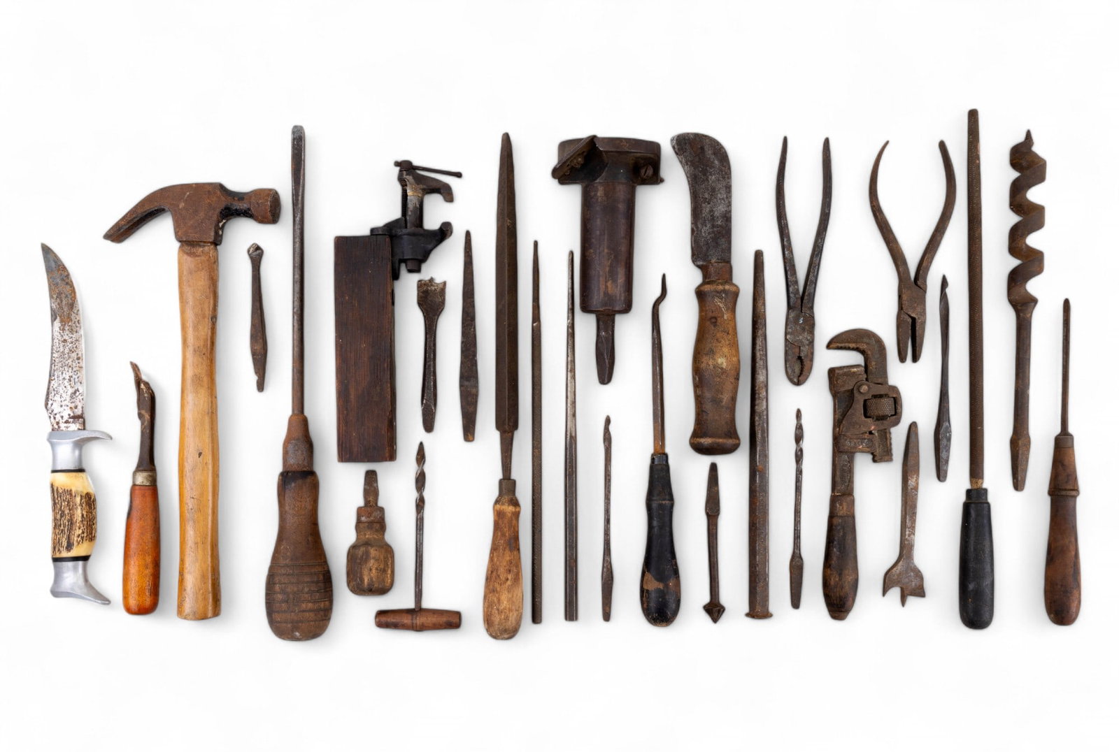 Antique / Vintage Hammer, Wrench, Chisels, & More: Antique / vintage hammer approx. 11.25" long, Trimo wrench, Original Buffalo Skinner knife w/ carved bone handle, chisels, drills, & other tools. There are 28 total tools. All pieces have wear and los