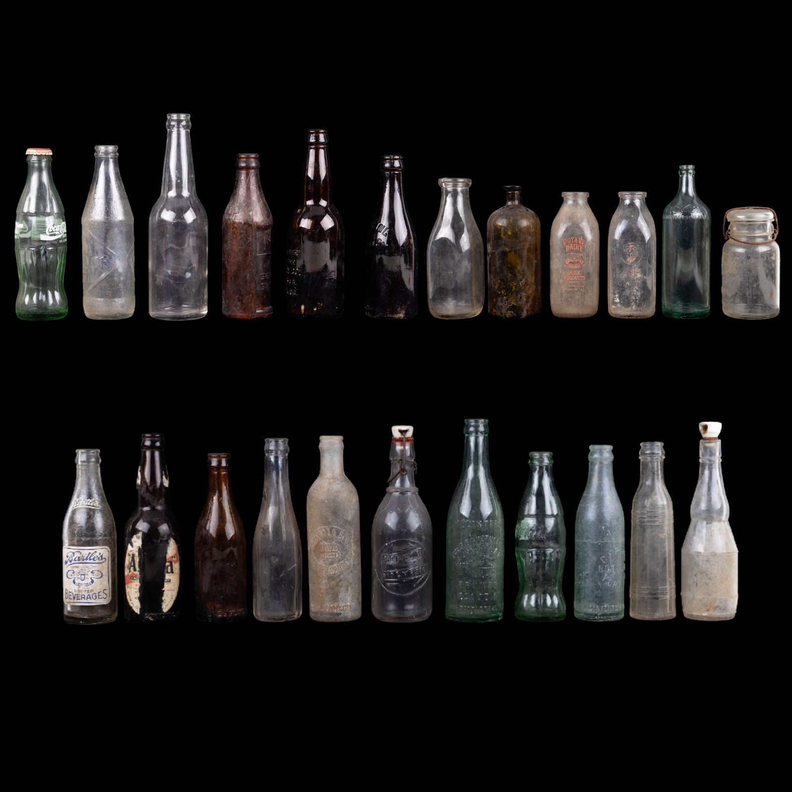 Vintage and Antique Bottles: An assortment of vintange and antique beer bottles, soda bottles, milk bottles, Ball jar with glass latching lid, and medicine bottles. Some of the brands include Yuengling Lager, Moxie, and Coca Cola
