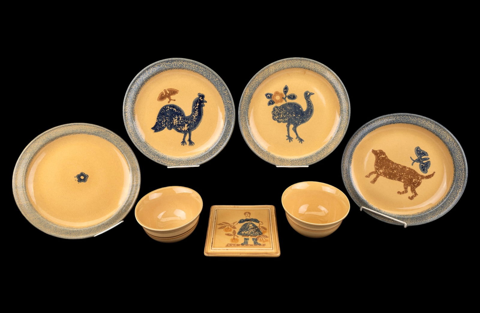 Vintage Pfaltzgraff Folk Art Design Pottery: Four large Pfaltzgraff dinner plates, each depicting a different scene, matching trivet, and two soup bowls. Marked 615 MAFA, other MAFA, 1983 The America Collection