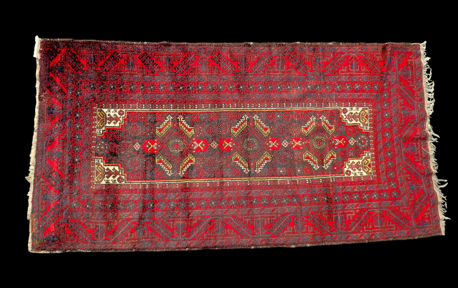 Vintage Turkish Rug: Vintage Turkish rug , likely from Anatolia, approx. 3'10" x 7' w/ burgundy, red, blue, yellow, & ivory patterns w/ geometric & floral motifs. Some fringe loss. *All rugs / carpets are used & come from
