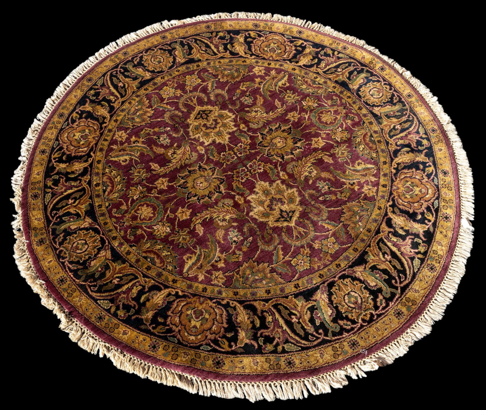 Indian Jaipur Circle Rug: Indian Jaipur circle rug approx. 6' in diameter w/ burgundy, green-gray, black, cream, gold, & tan patterns w/ floral motifs. *All rugs / carpets are used & come from fine estates. Keystone Auctions d