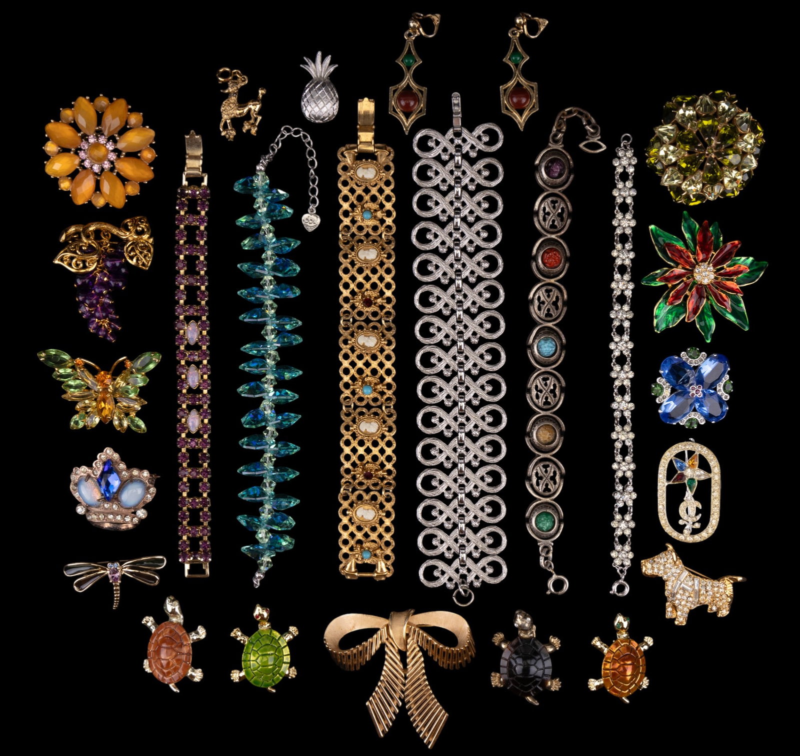 Turtle Brooches and Trifari Jewelry: Four gold tone turtle brooches, three are enamel and the fourth is suspected tortoise shell, Trifari silvertone bracelet, pineapple brooch, and gold tone bow brooch, vintage Coro gold tone earrings wi