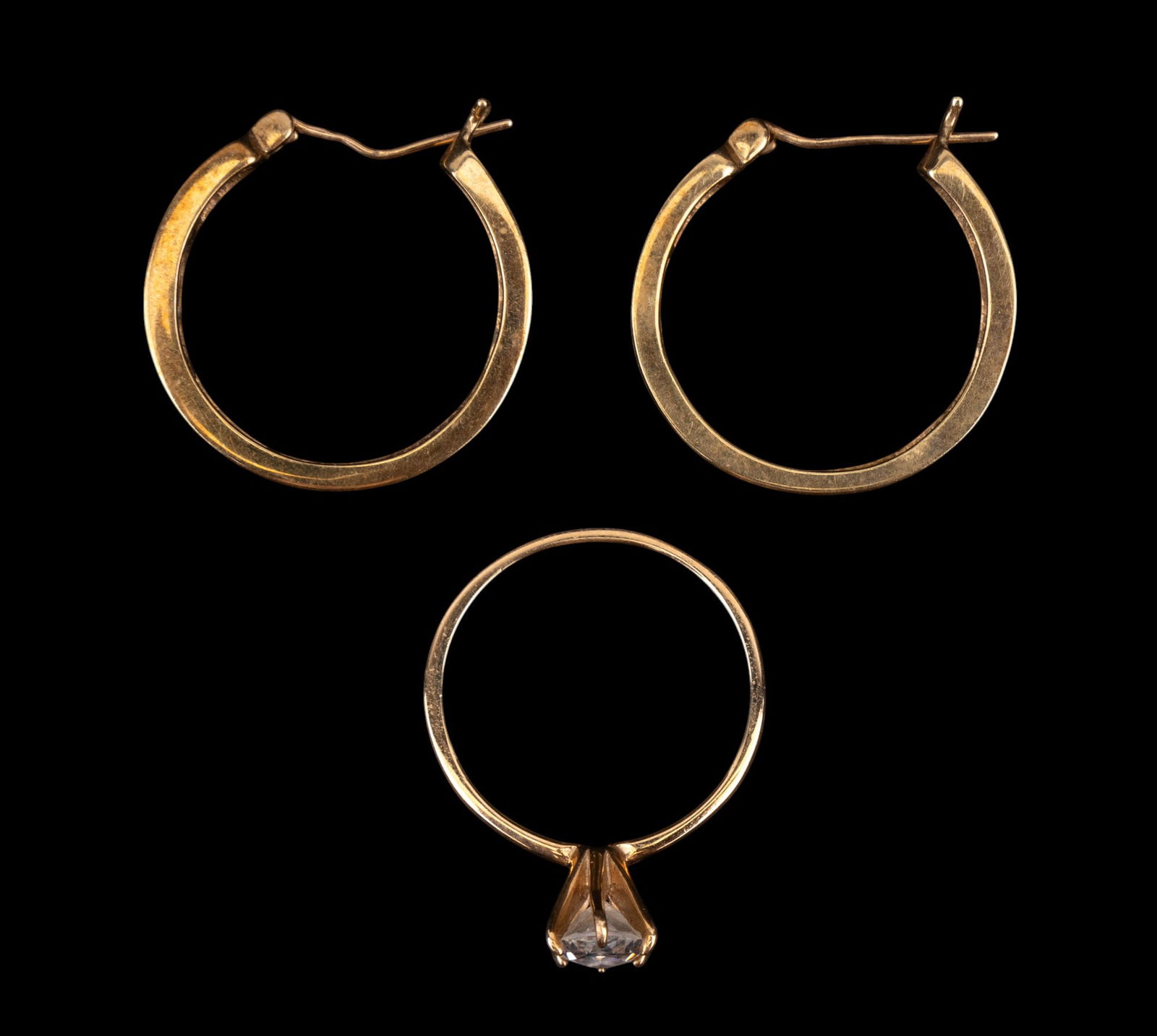 10K Hoop Earrings and Marquise Solitaire Ring: 10K gold hoop earrings have 1" drop and Marquise cut solitaire ring size 8.75", total weight is 7.9g. (We do not know what the stone is at this time.)
