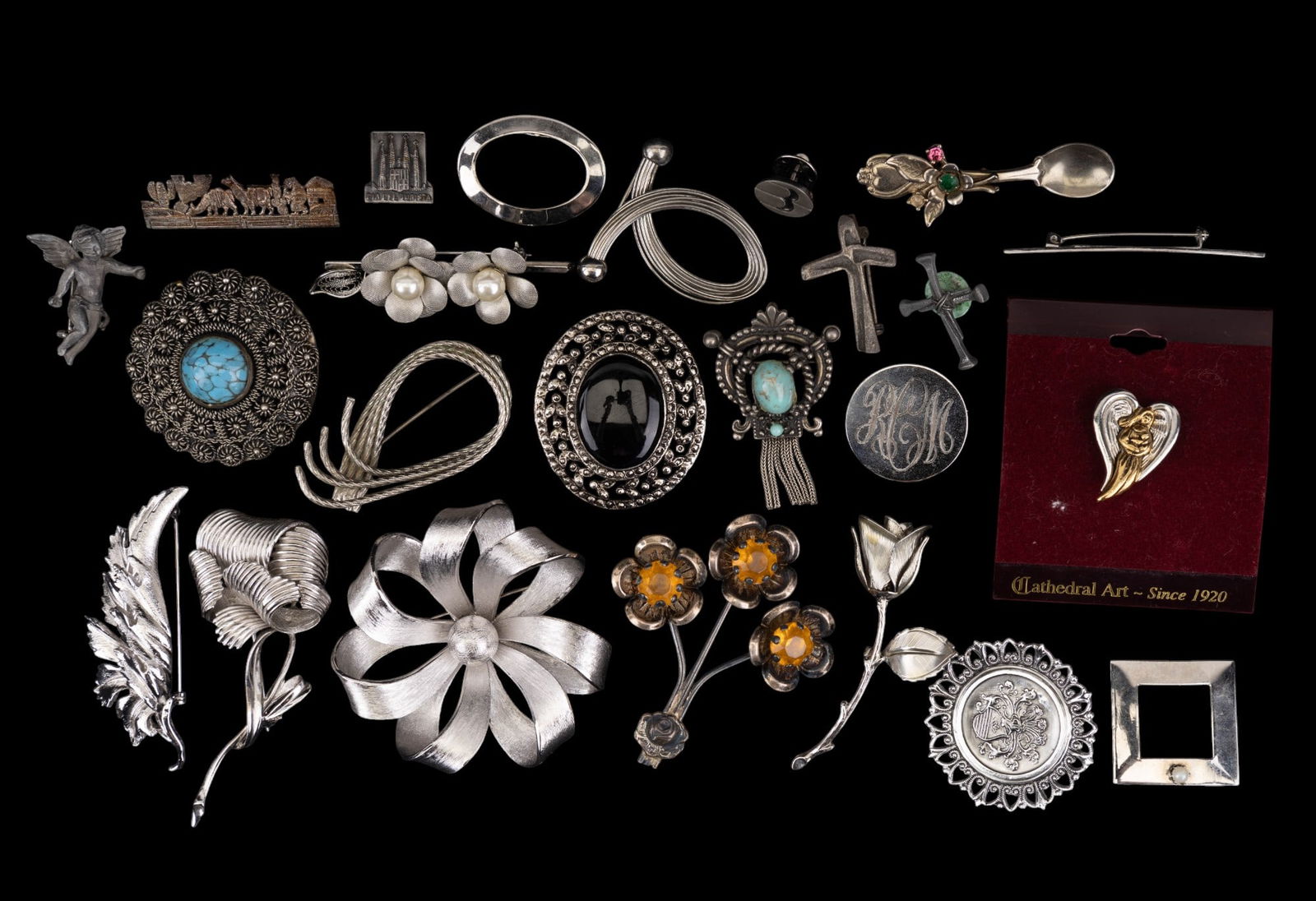 Vintage Silver Tone Brooches: A collection of 24 vintage silver tone brooches with faux pearl, turquoise, and rhinestones; two vintage Coro folded leaf and twisted flower brooches featured.