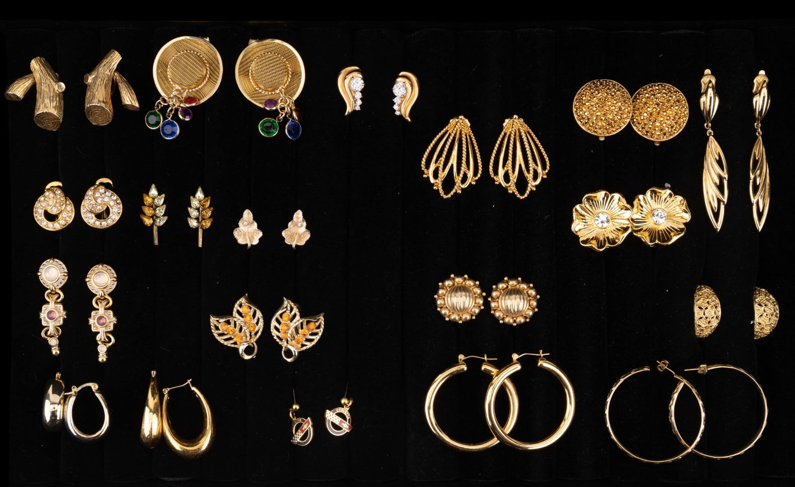Gold Tone Fashion Earrings: A collection of gold tone designer screw back, clip on, and pierced earrings by designers such as Monet Rembrandt, Trifari, St. John, Premier USA, Avon, and Coro. One pair of screw backs with yellow a