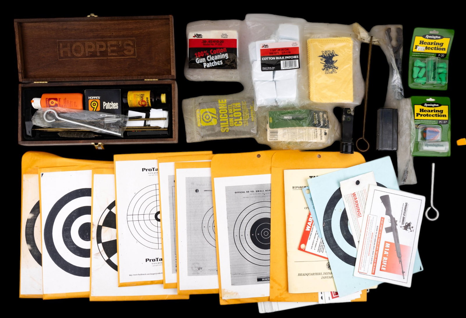 Gun Cleaning Kit, Paper Targets, & Gun Ephemera: Hoppe's 9 gun cleaning kit in original Hoppe's wood box, an assortment of other gun cleaning materials & tools, 8 packets of paper targets for different guns, 8 gun-related bumper stickers, & a few ot