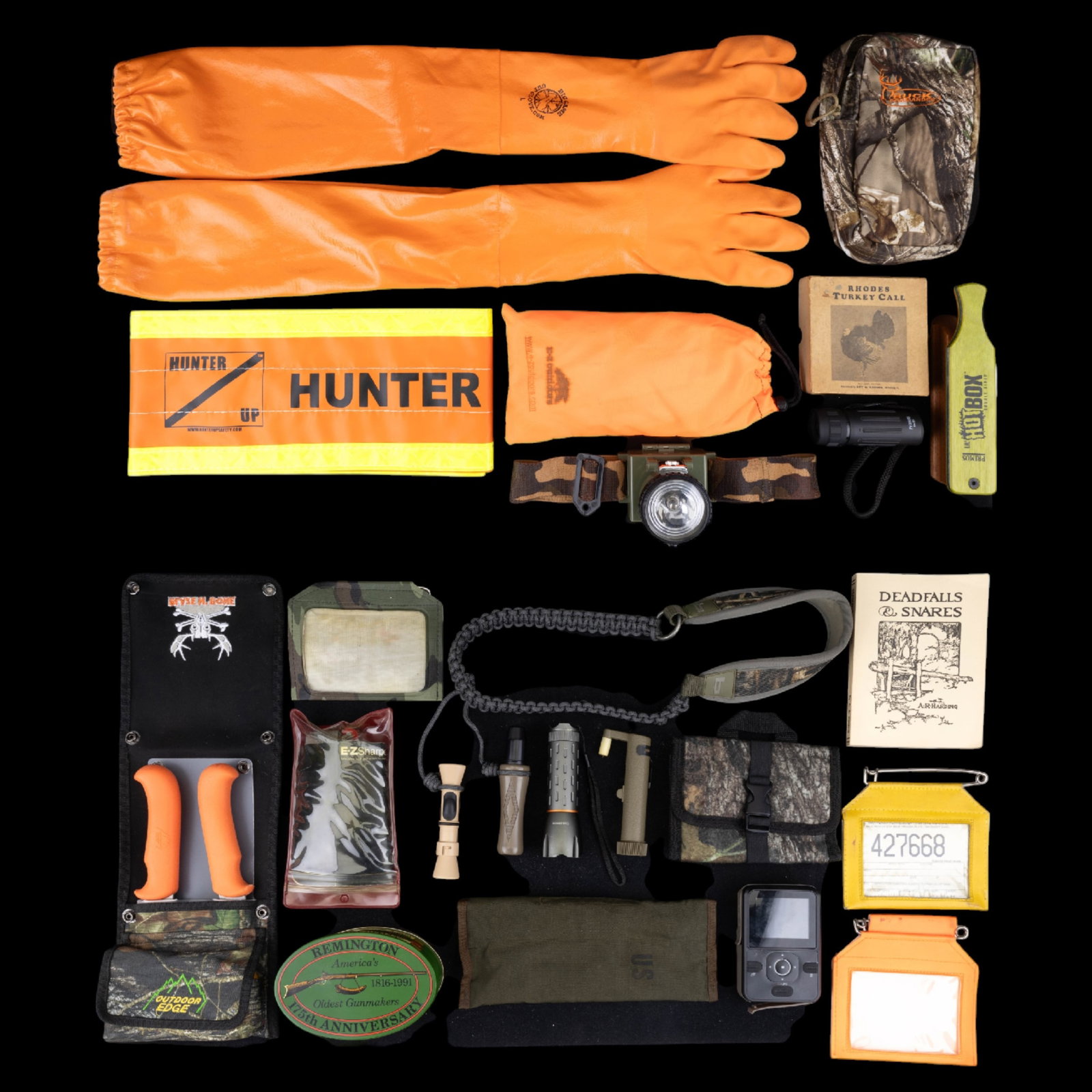 Hunting Calls and Variety of Gear: Hot Box brand Turkey Call, Rhodes turkey call, two deer calls, misc. head gear, skinning tools and gloves, safety reflective hunter belt, flashlights, possible trail camera, and more.