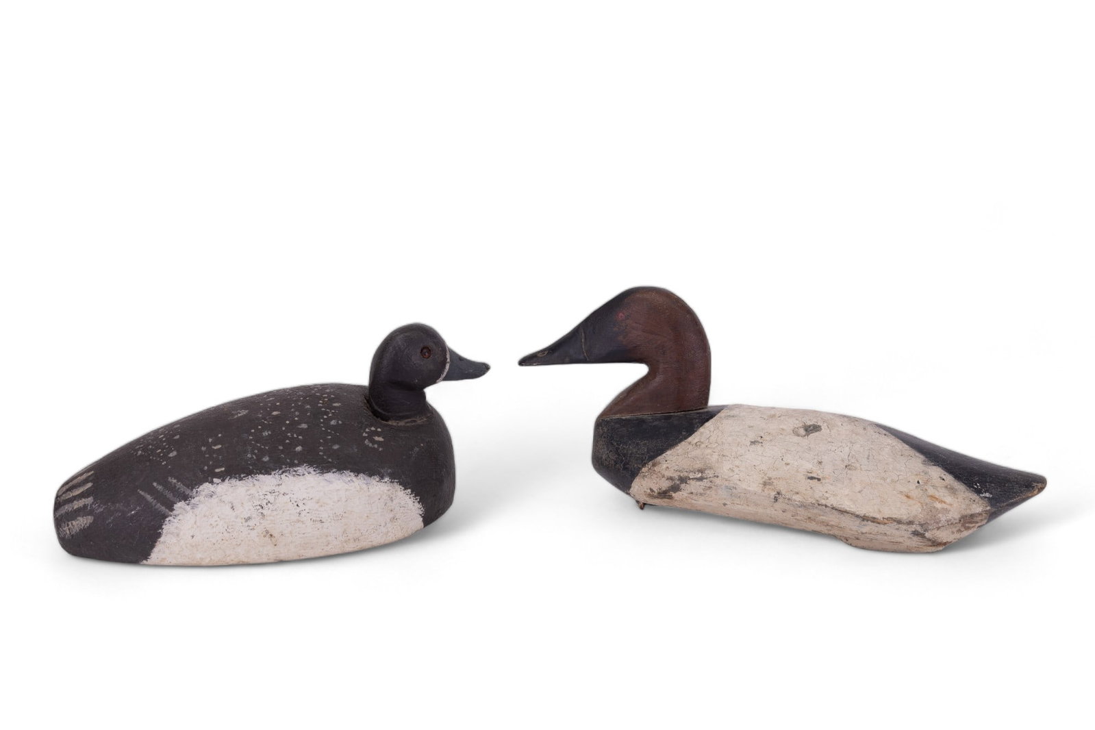 Antique Duck Decoys (2): Michigan Greater Scaup (bluebill) duck decoy that measures approx 14" long. Item has glass eyes & is unsigned. Other decoy is a Canvasback Drake duck decoy that measures approx 17" long. Item has 2-D 