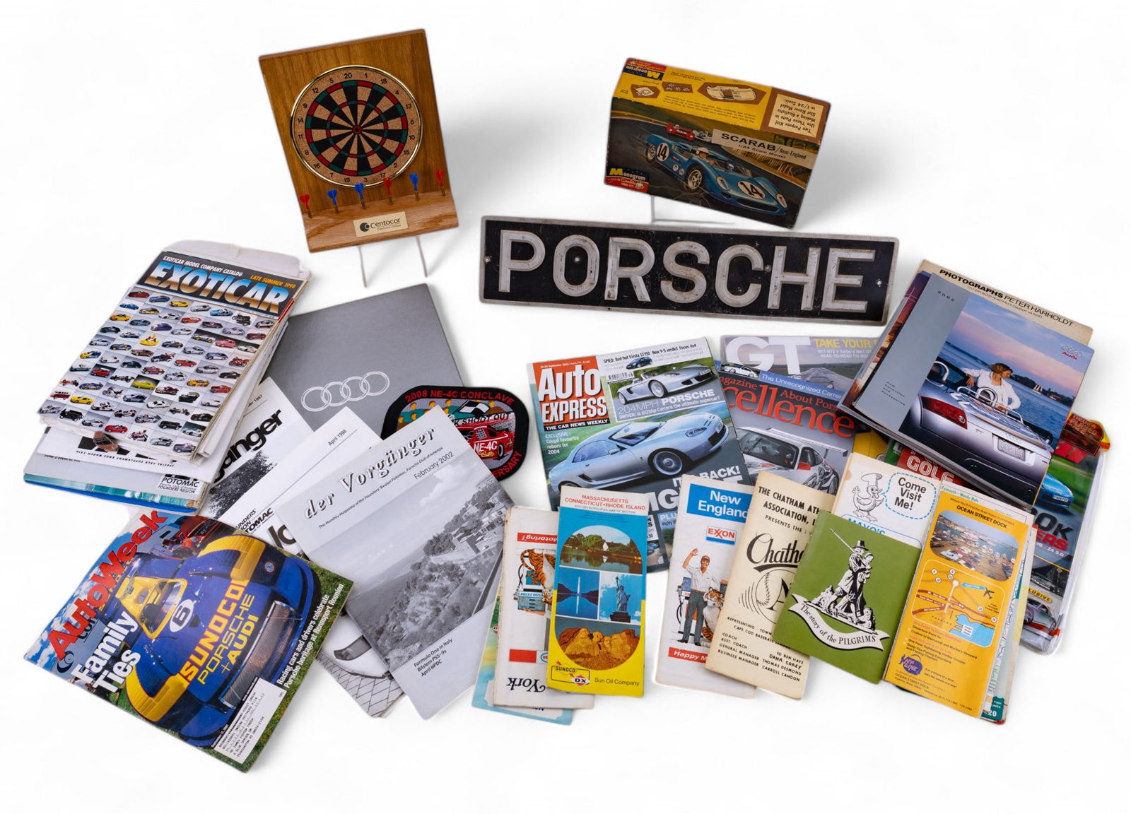 Porsche Metal Sign and Automotive Magazines: Porsche metal wall plaque 20.5x4.5", Scarab 1/24 scale model kit, Top Gear magazine, desktop dart board, and more.