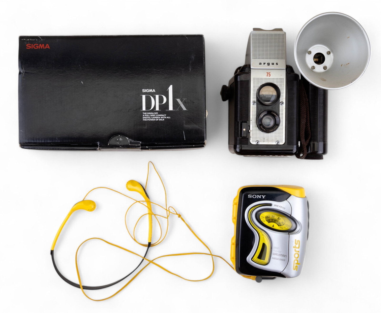 Vintage Argus and Sigma Cameras, Sony Walkman: Argus "75" camera with flash - untested. Sigma "DP1x" digital camera in original box with all components. Sony "WM-FS111" Sports FM/AM Walkman with headphones.