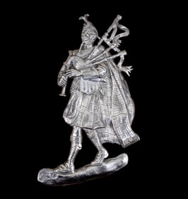Cast Metal Relief Scottsman Playing Bagpipes