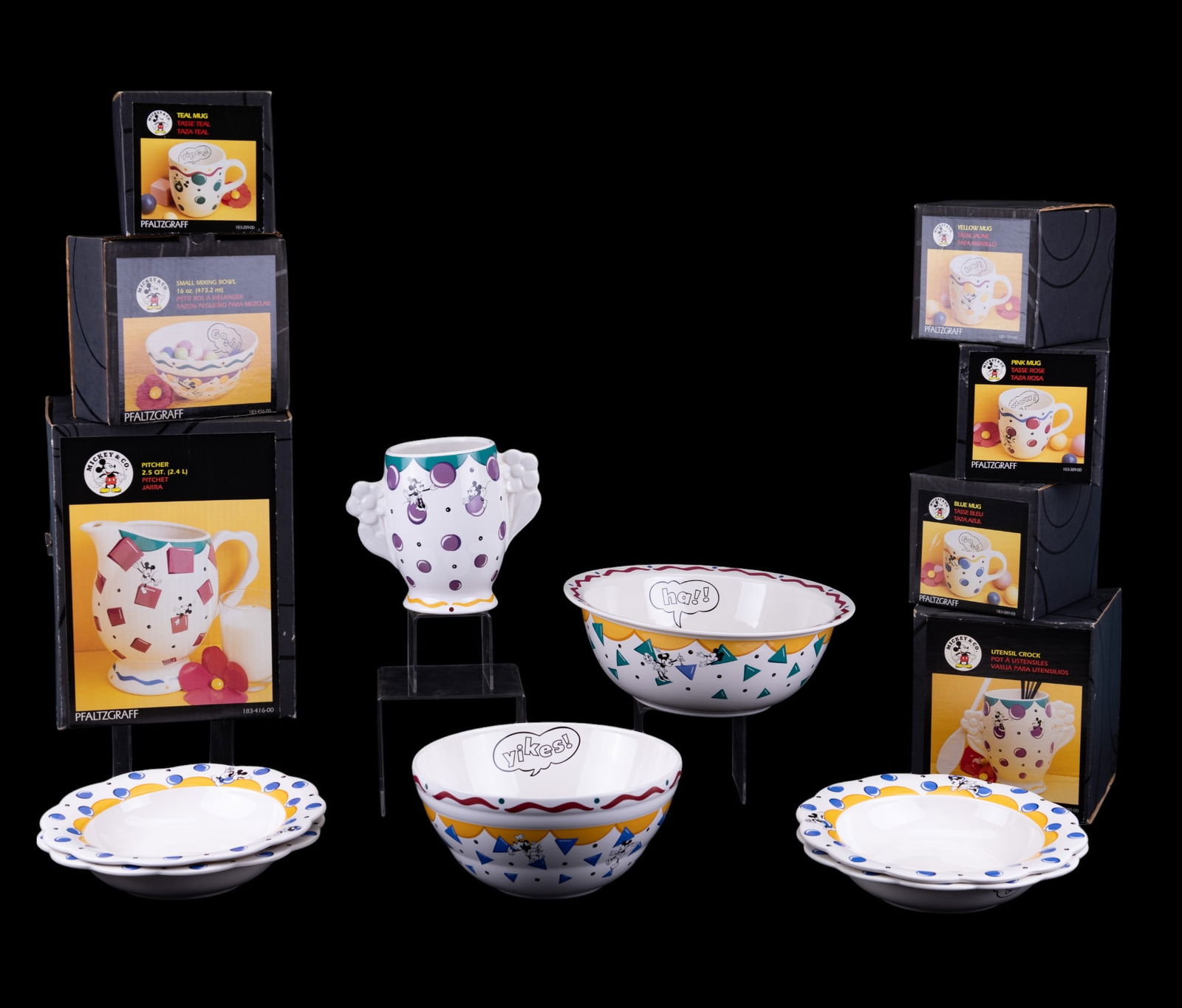 Pfaltzgraff Mickey & Co. Dishes (14 pcs): 14 pieces of Pfaltzgraff Mickey & Co. dishes with a triangle, square, and circle patterns. Pieces in original boxes include: pitcher, large mixing bowl, small mixing bowl, utensil crock, 4 coffee mugs