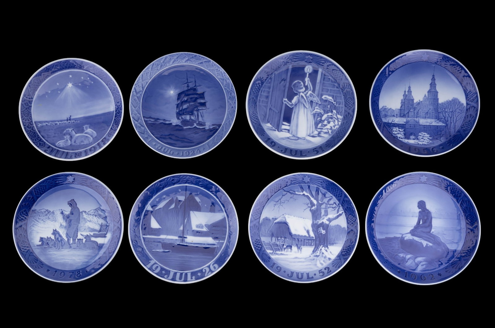 Royal Copenhagen Christmas Plates: A collection of eight Royal Copenhagen Christmas plates including designs such as1918 The Shepherds, 1978 Greenlandic Scenery, 1926 Canal in Copenhagen, 1924 Schooner at Sea, 1952 Feeder in the Deer G