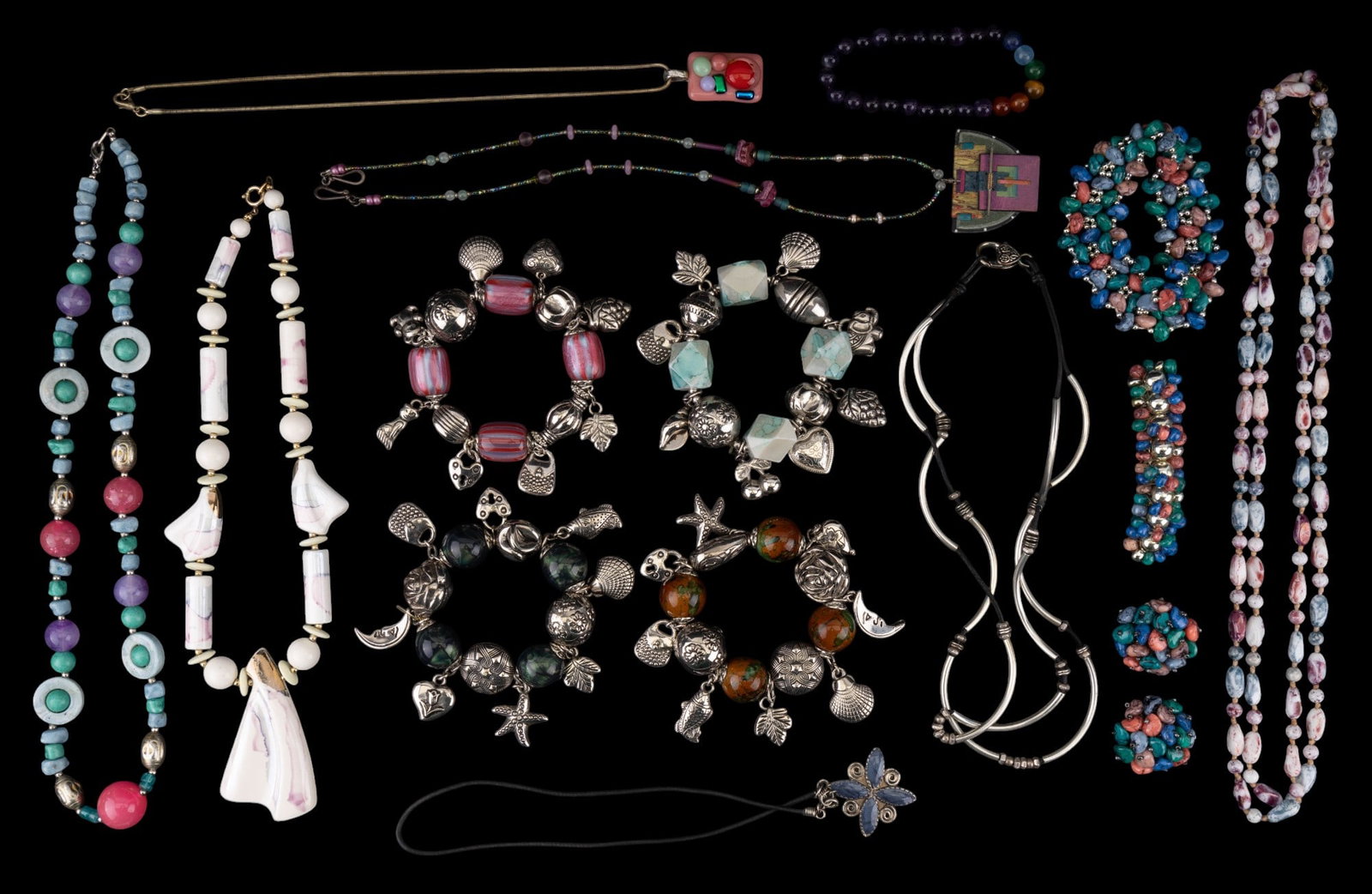 Colorful Bead Jewelry & Charm Bracelets: Assortment of stone & glass bead jewelry w/ pastel colors, silver tone charm bracelets w/ unique colored beads, & black rope & silver tone necklaces. There are 6 bracelets, 7 necklaces, & a pair of ea